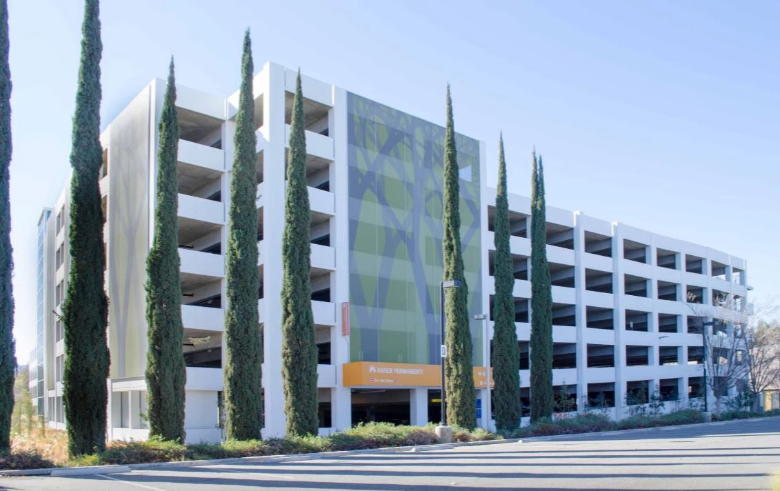 The tree motif facade hidden behind real trees, blending in with it's surroundings.
