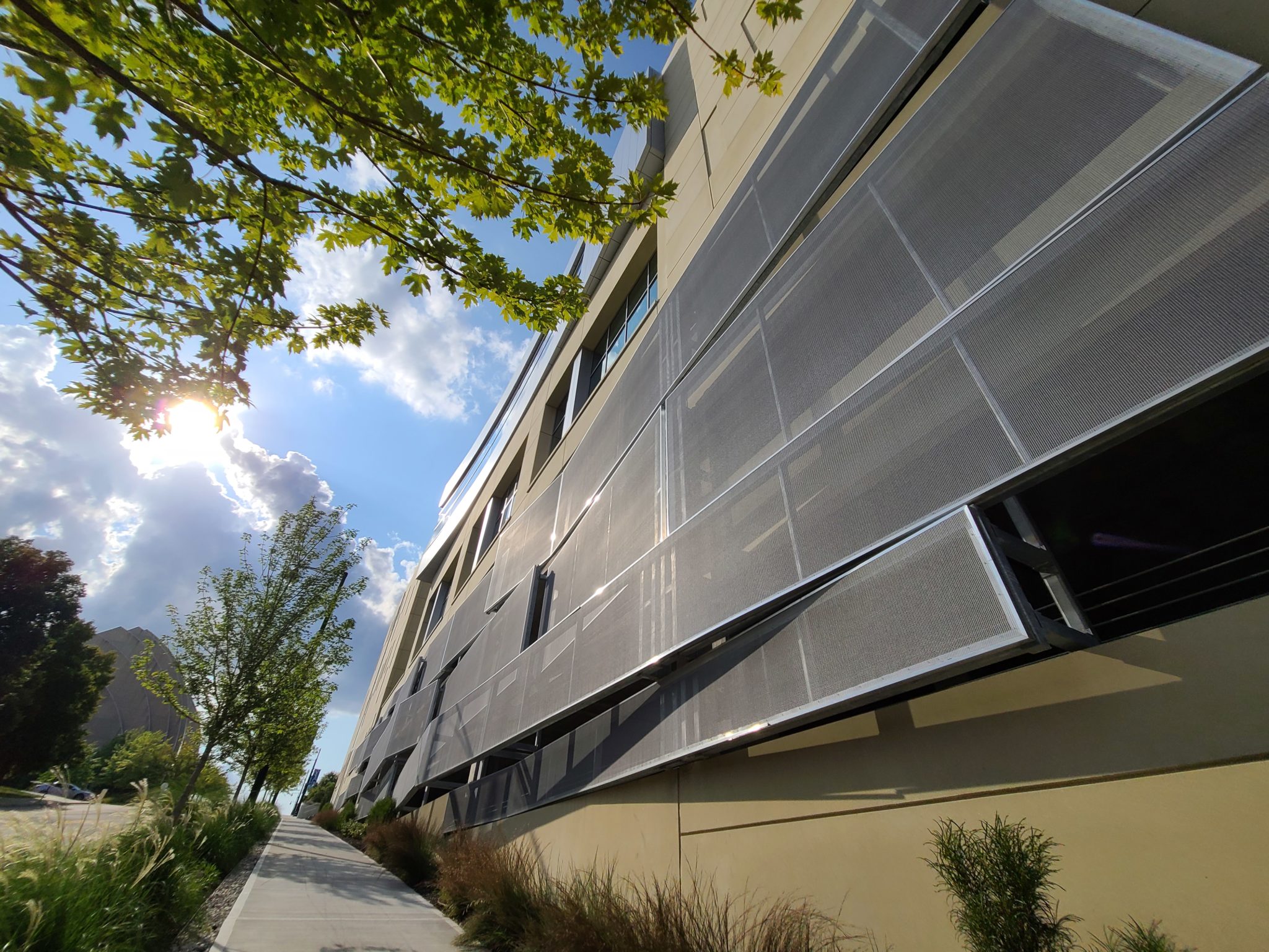 A view from the sidewalk that shows the side of the facade that swoops out.