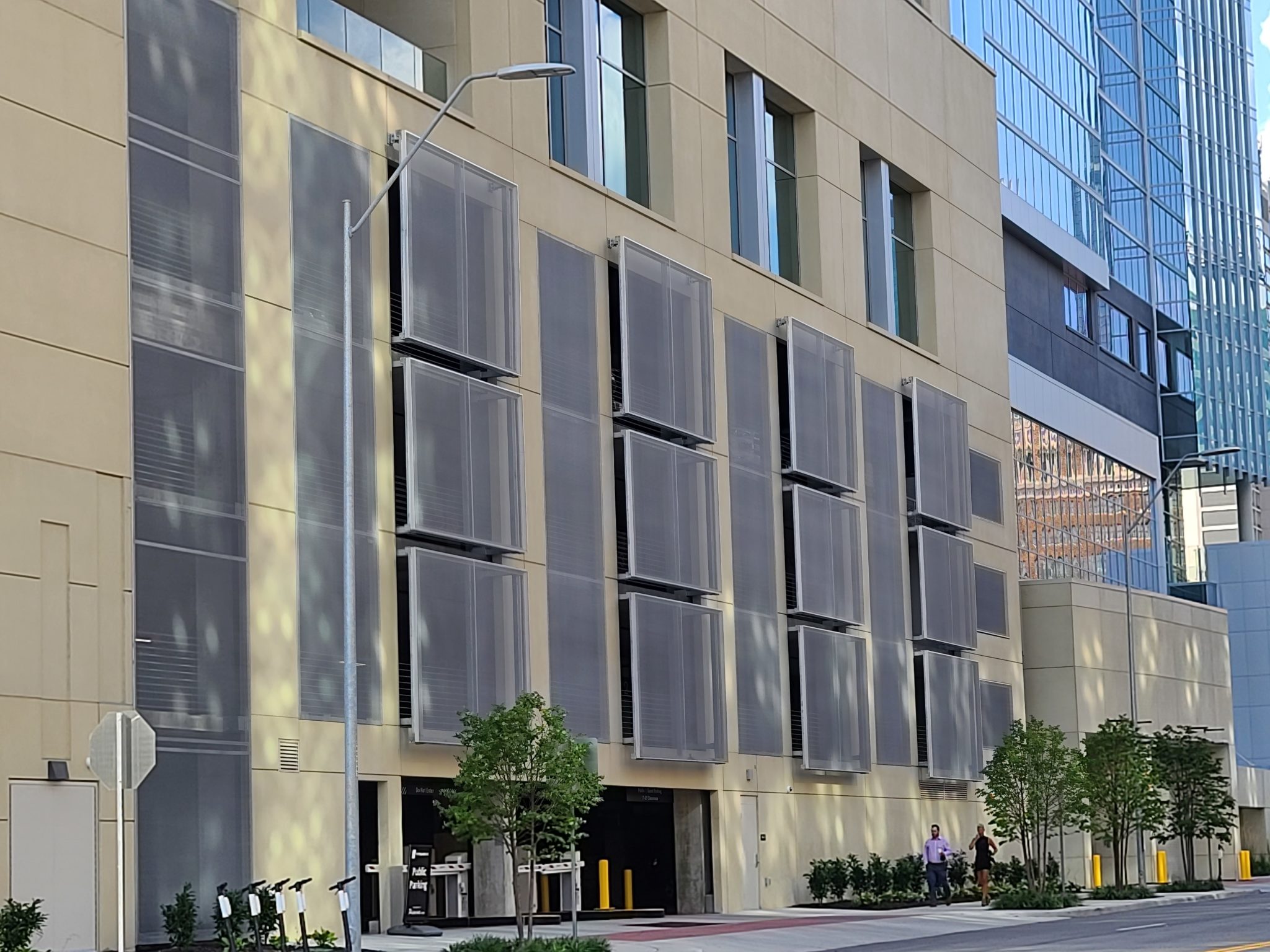 A view from across the street of the side of the facade that sticks out in a checkered pattern.