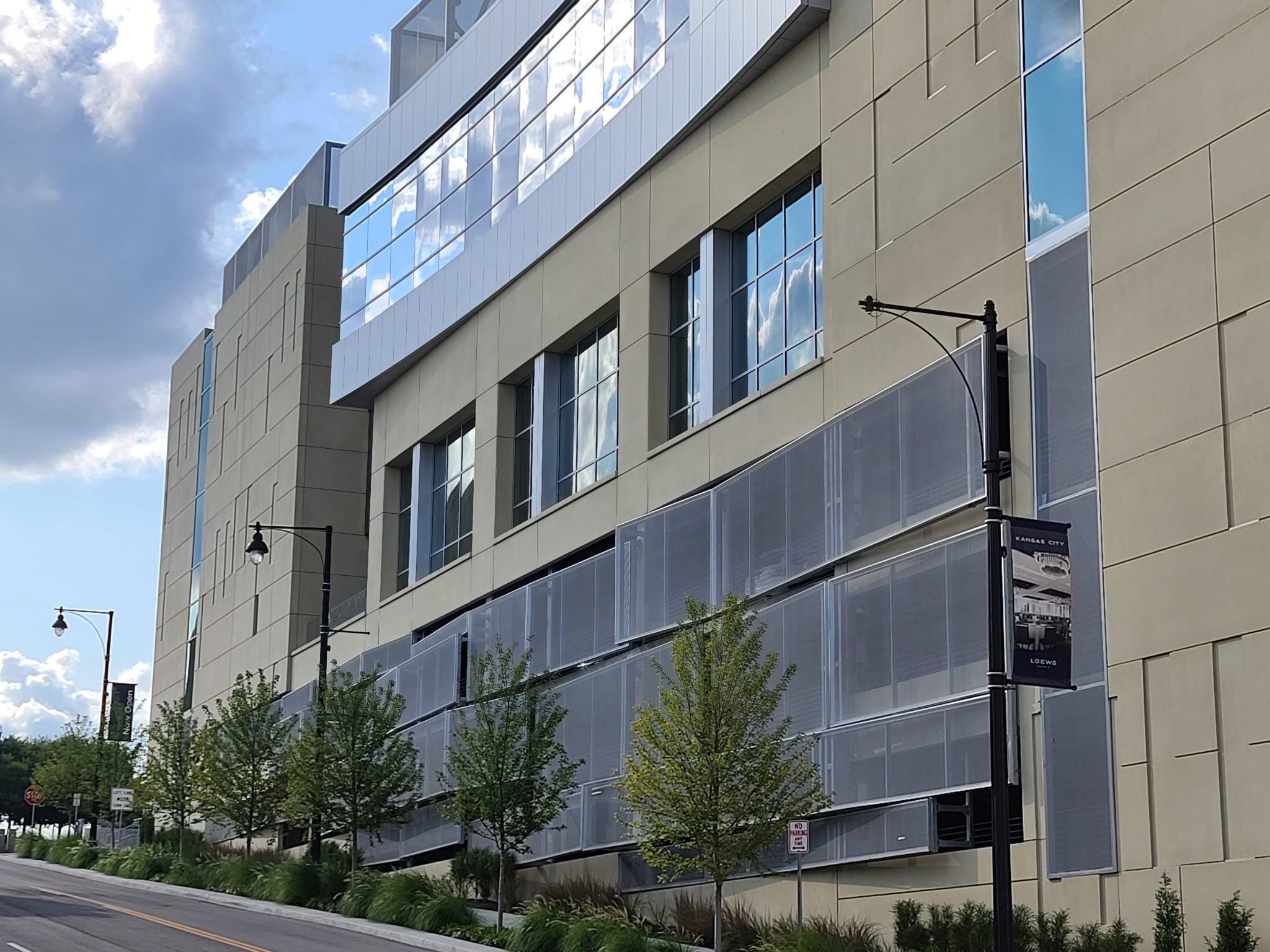 A view from across the street of the side of the facade that swoops out.