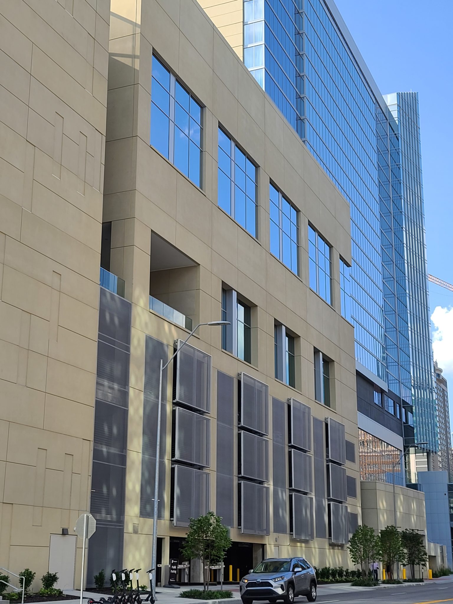A street view of the square patterned facade sticking out.