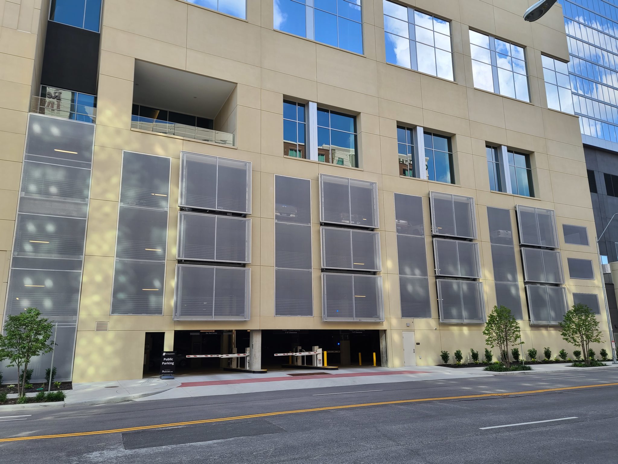 Sidewalk view of the side of the facade that sticks out in a checkered pattern.