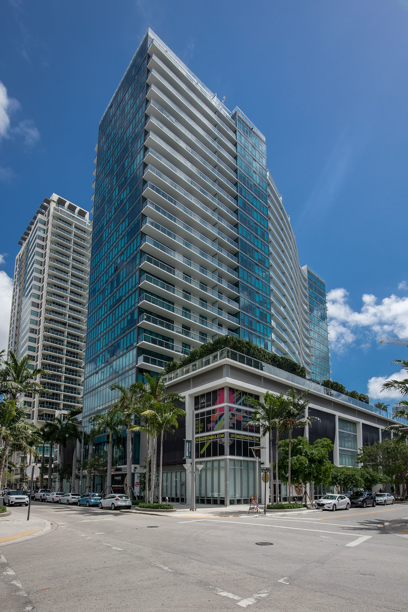 A zoomed out image showing the entire building and the facade in context.