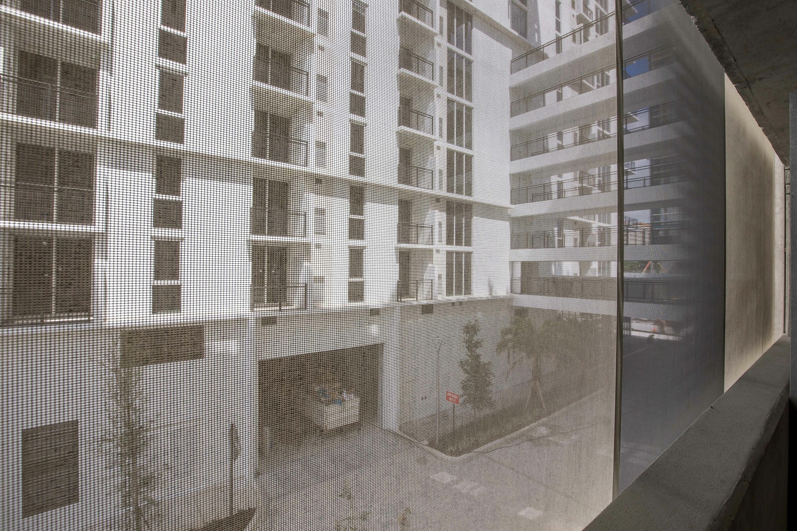 A view from inside of the parking garage looking out through the facade.