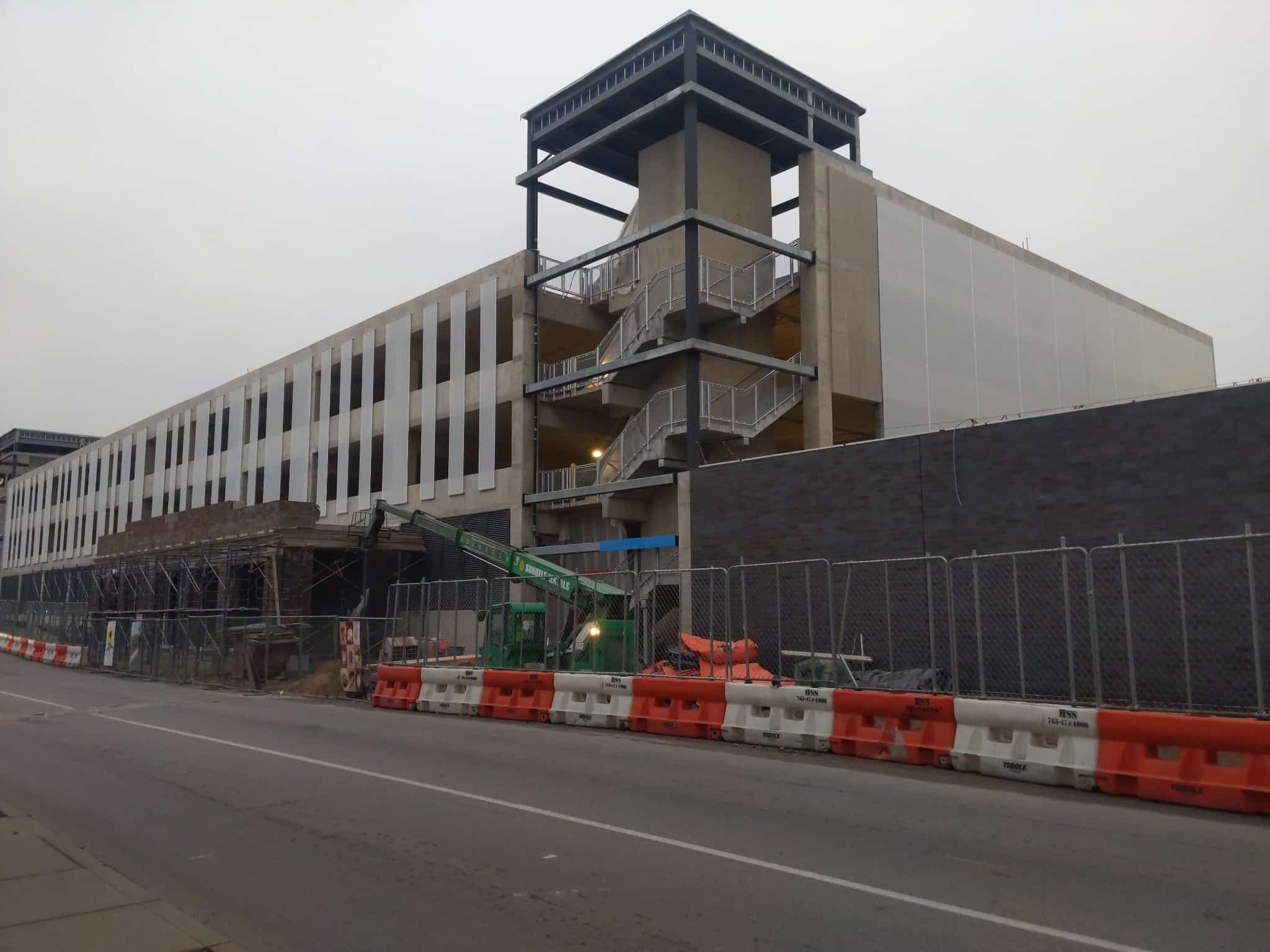 A view of the corner showing one side with the slotted facades and the other with a flat white facade.