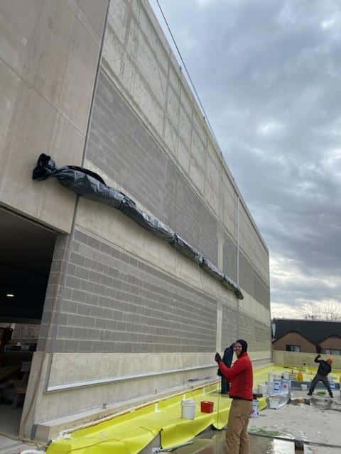 Process photos of the facade being installed.