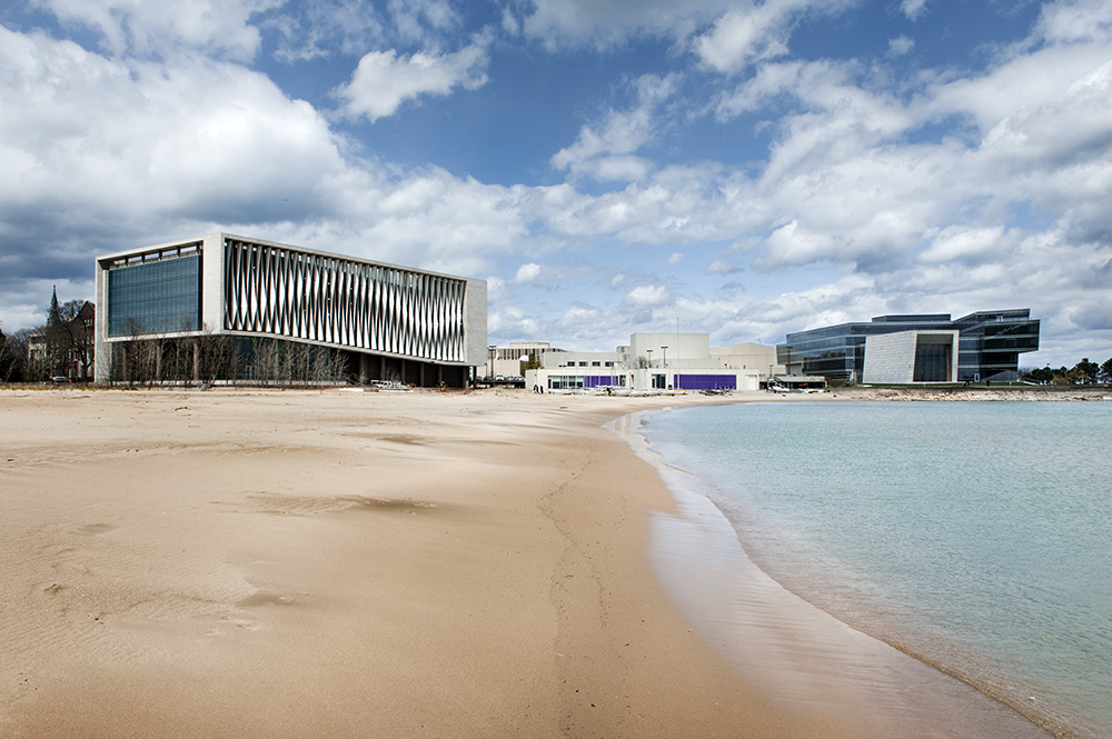 A shot taken far away from the building showing it in context with its surroundings on the beach.