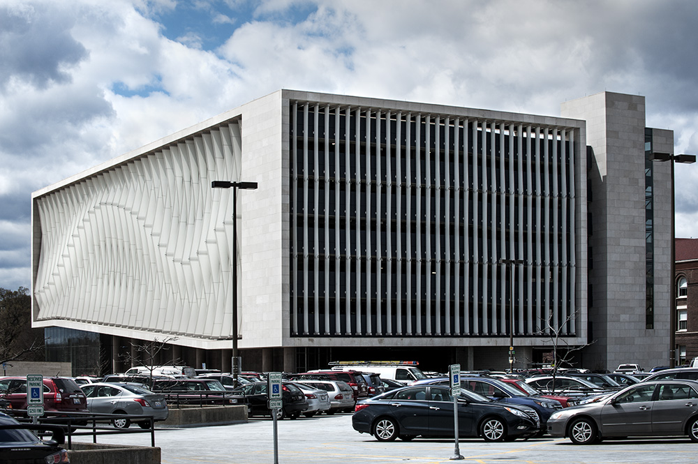 A white finned facade with the fins coming to a point at different spots. The points are staggered which creates a wave effect when the fins are lined up.