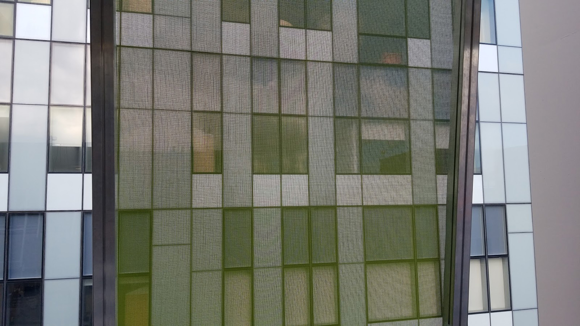 A view from inside the parking garage looking out through the facade.
