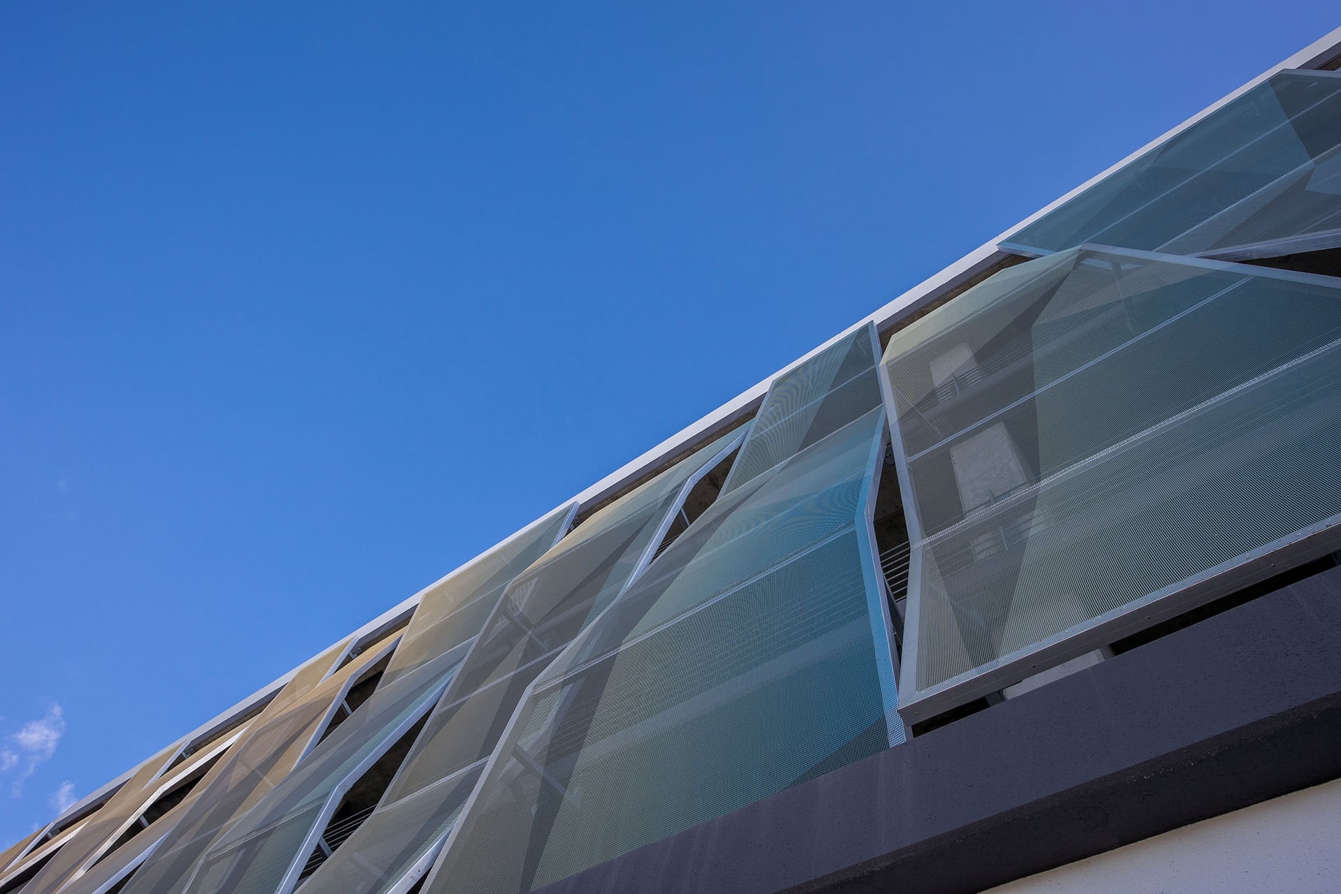 A view of the facade from the sidewalk.