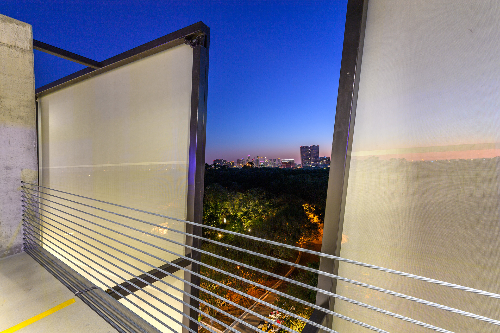 A view from the top of the parking garage looking out onto the surrounding campus through the facades.