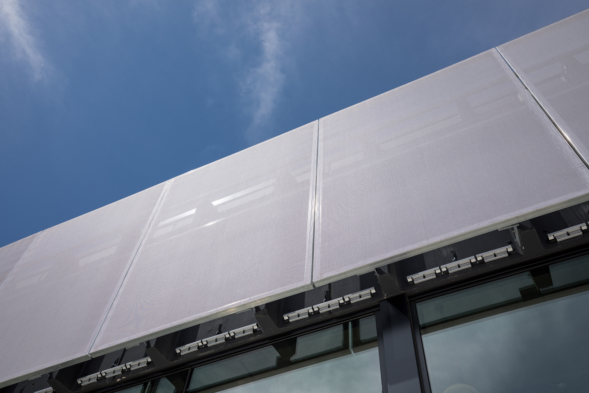 A view from the sidewalk showing the panel thickness.