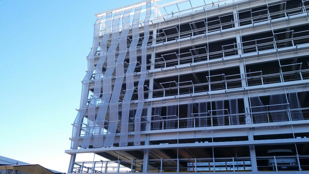 Process photos of the facade being installed.