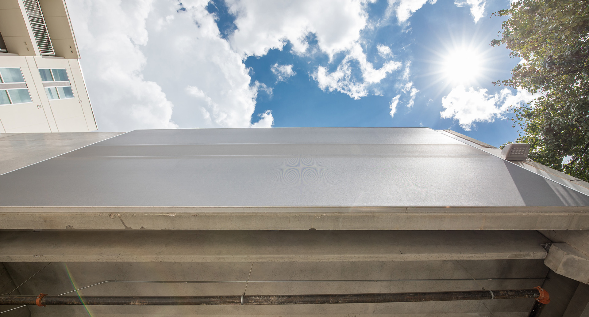 A view from the sidewalk looking up at the facade, showing it flush.