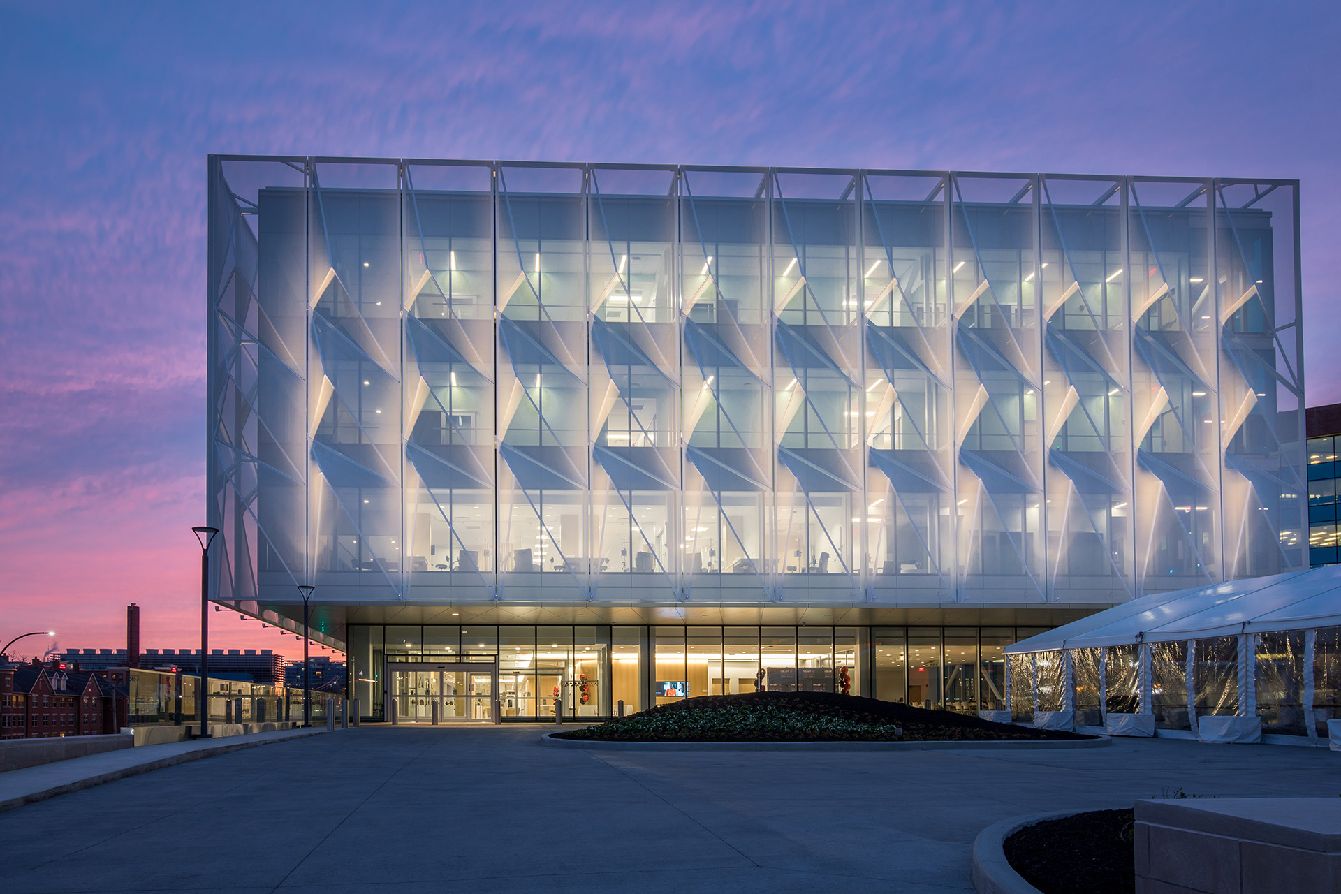 Another view of the facade at night with the light shining through.