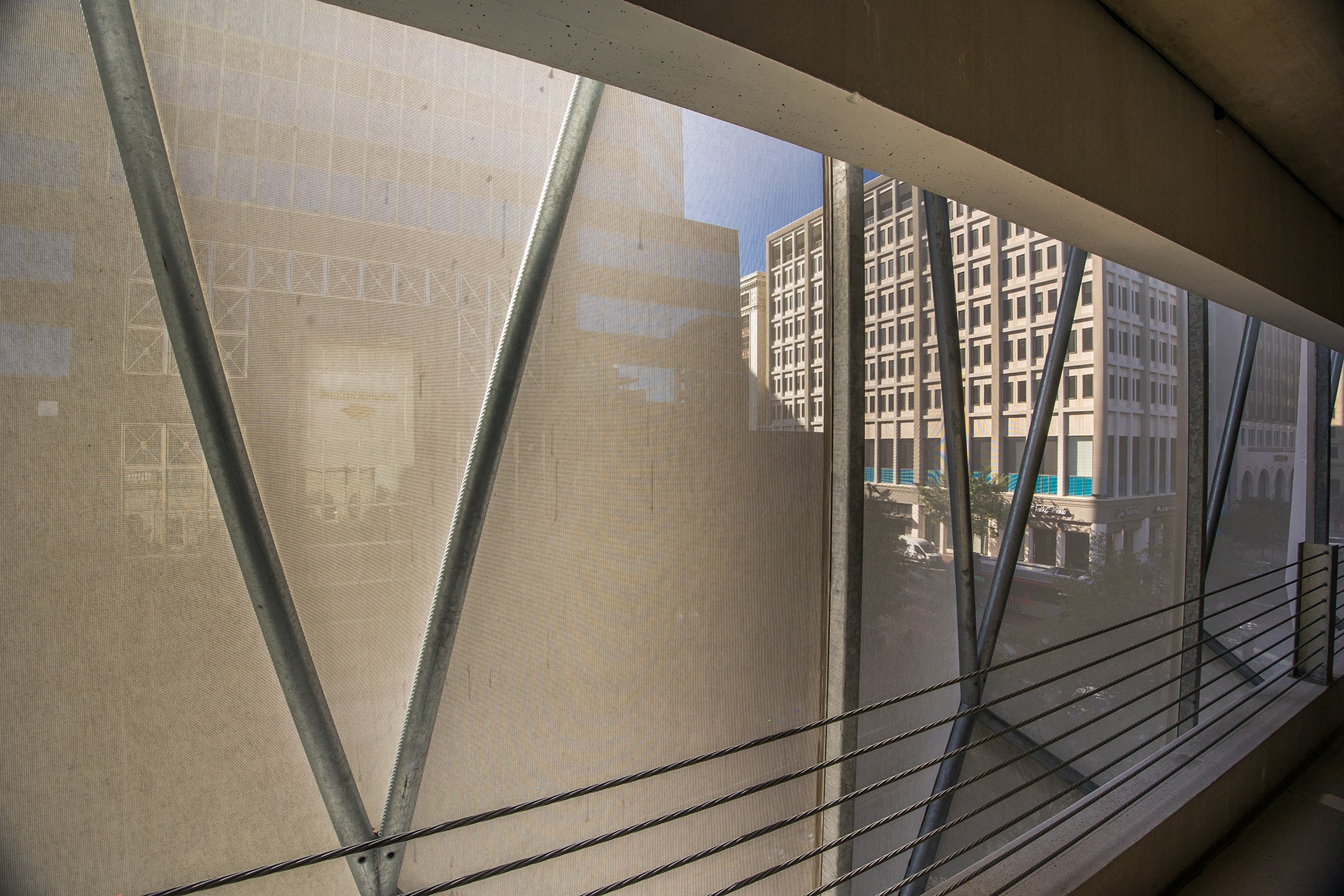 A view from inside of the parking structure looking out through the facade.