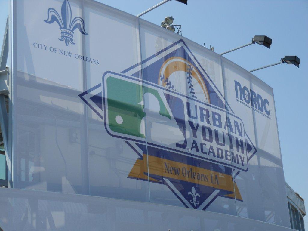 A white branded facade with the logo for an urban youth academy.