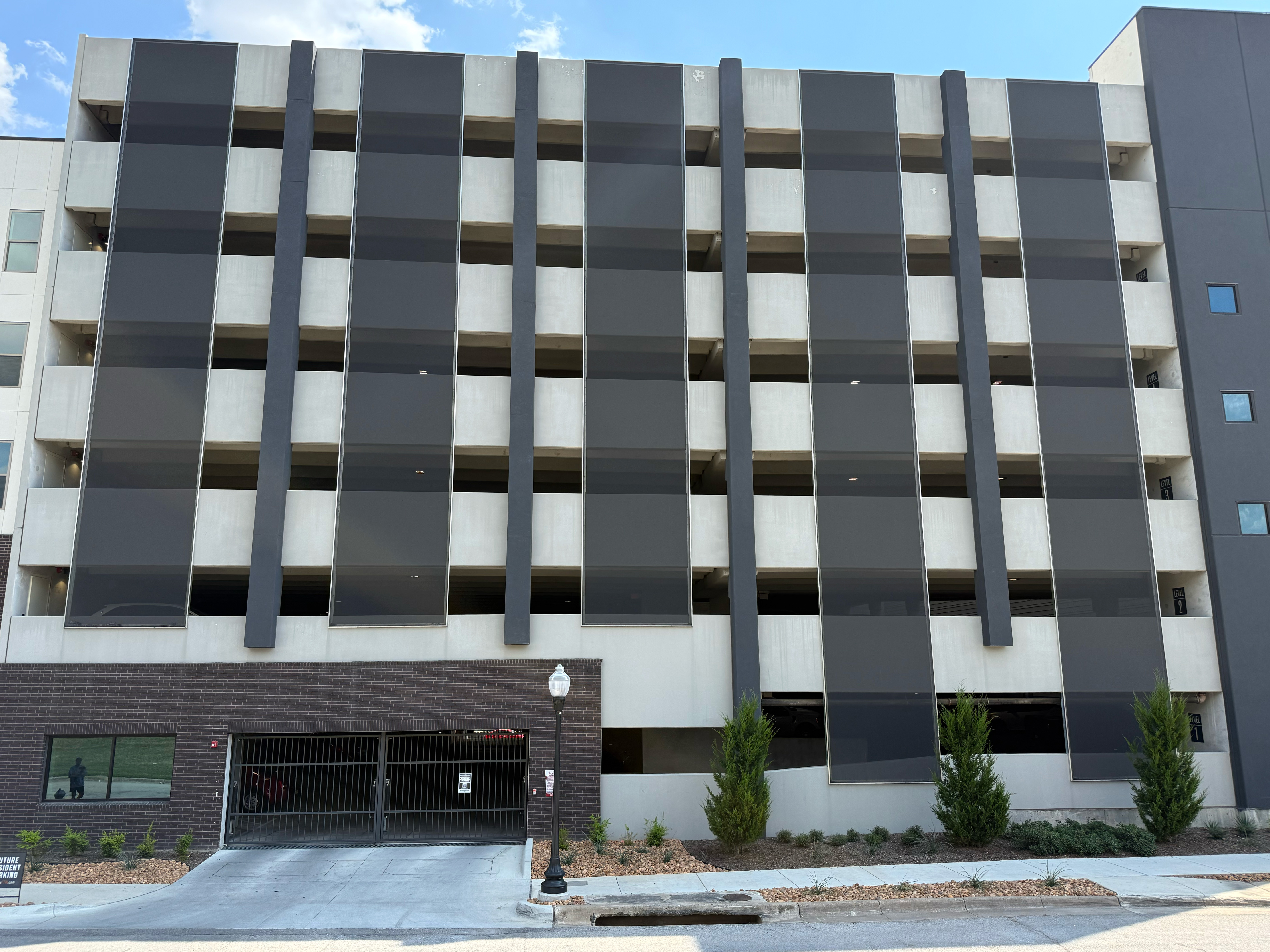 Black slotted facade sat across the face of a parking structure.