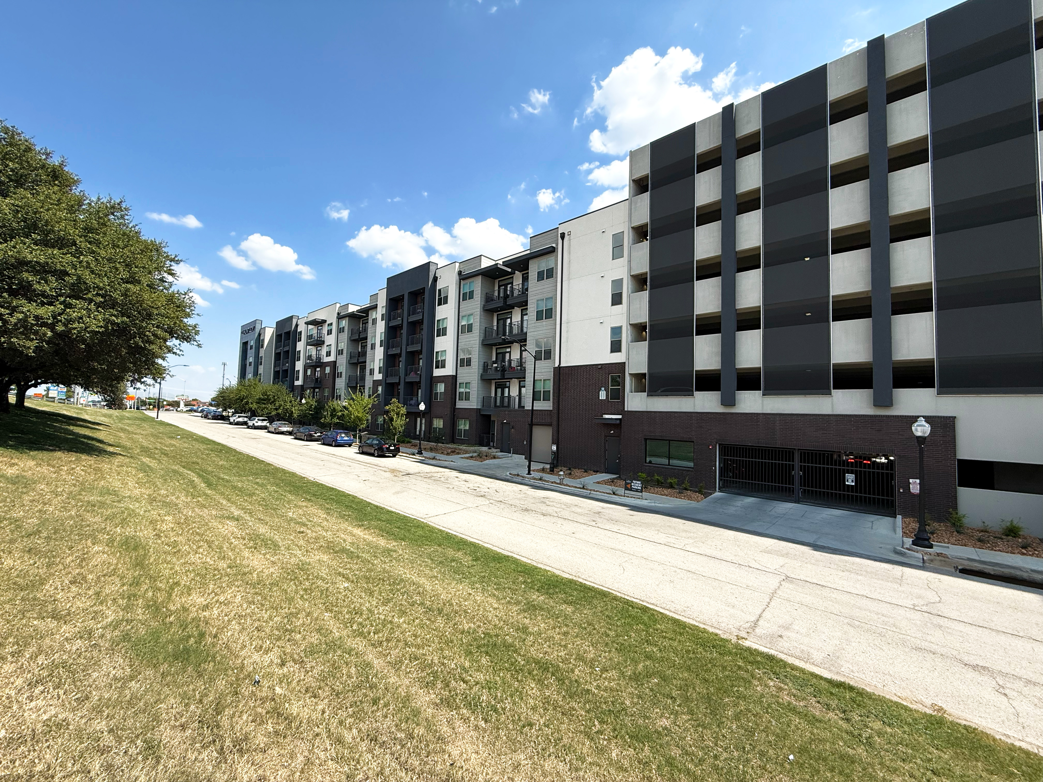 A wide view fo the entire parking structure showing the facades in context.
