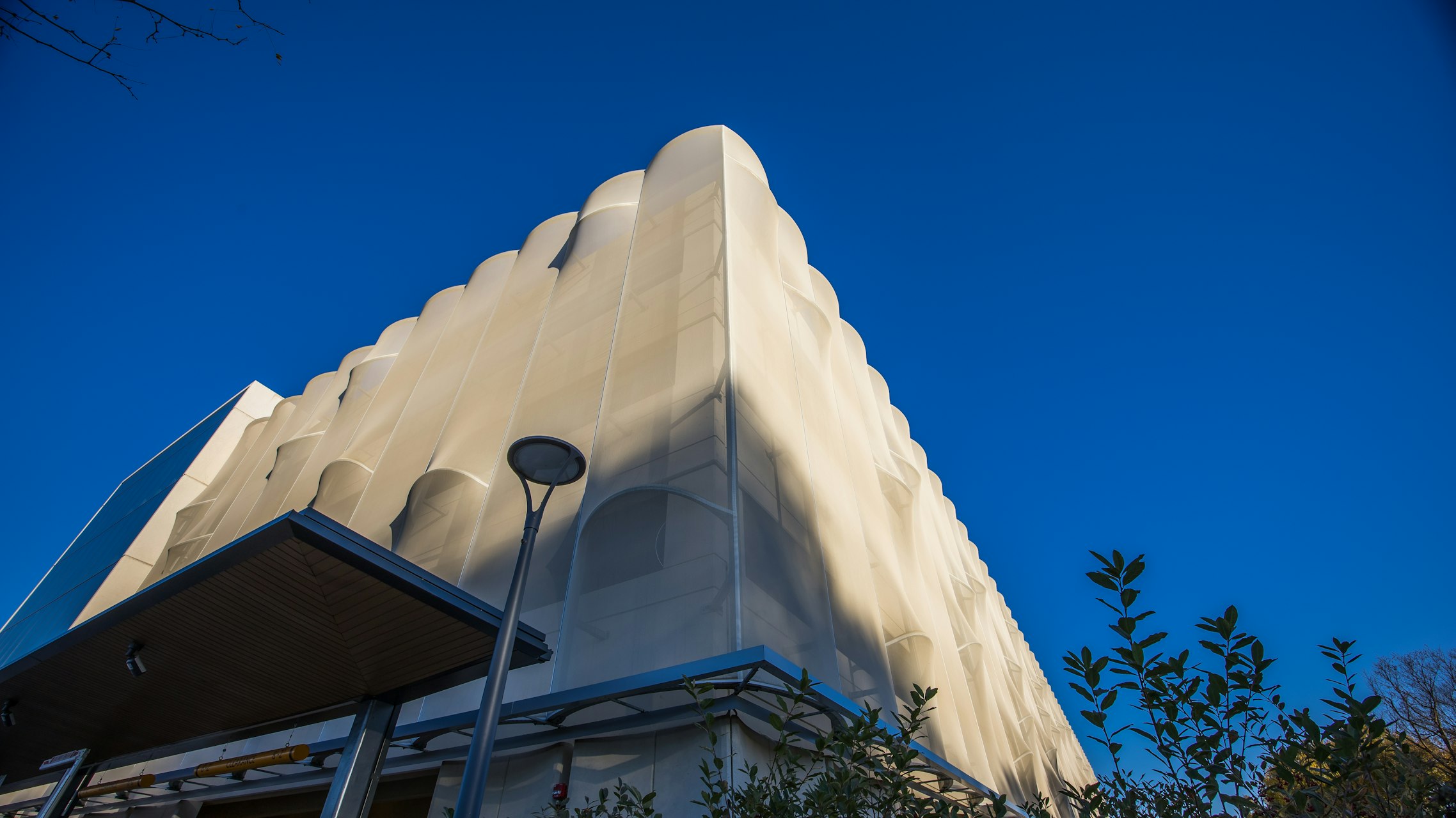 A wide view shot of the corner of the facade.