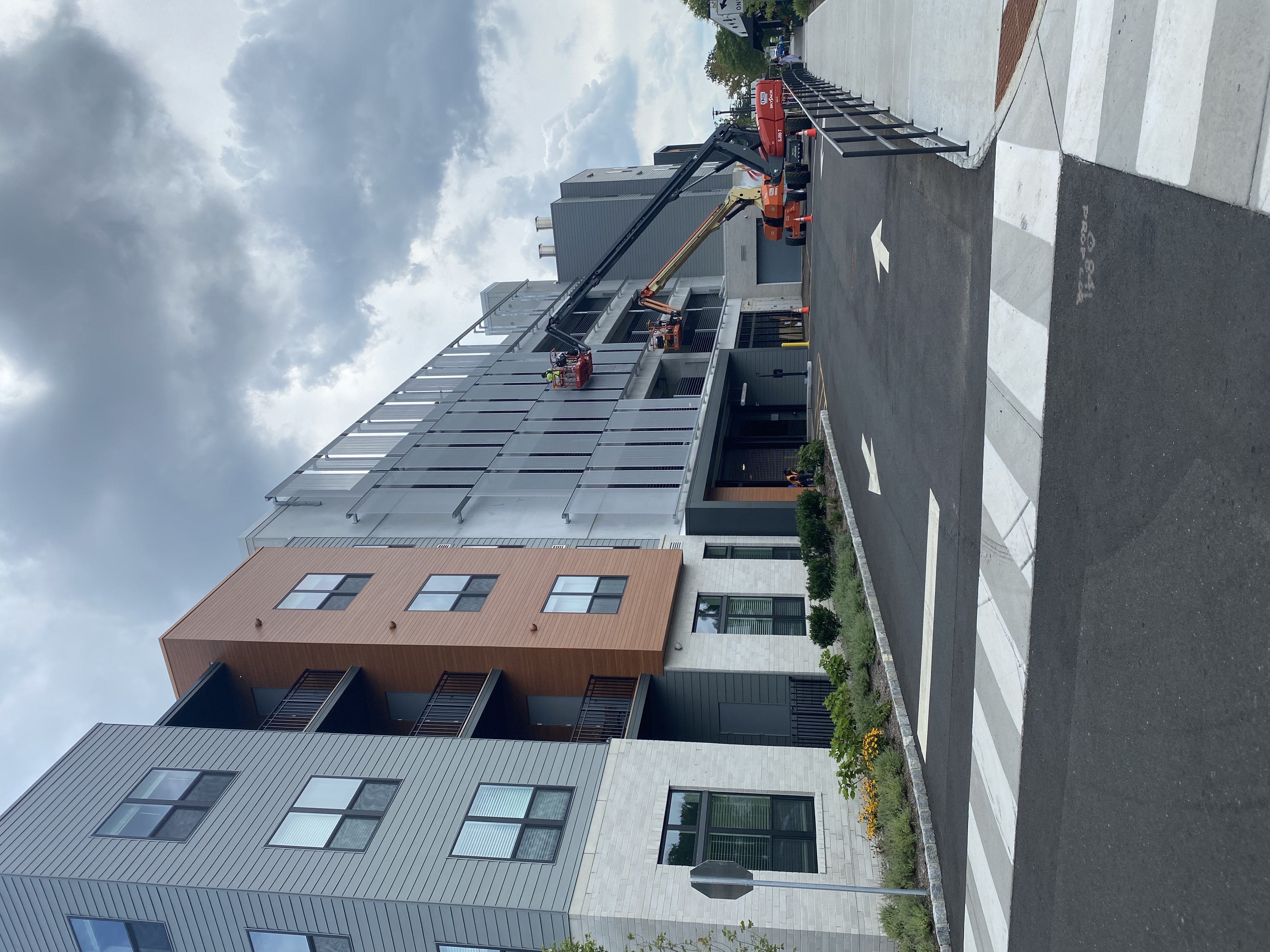 A view of the facade from down the street, showing it blend with it's environment.