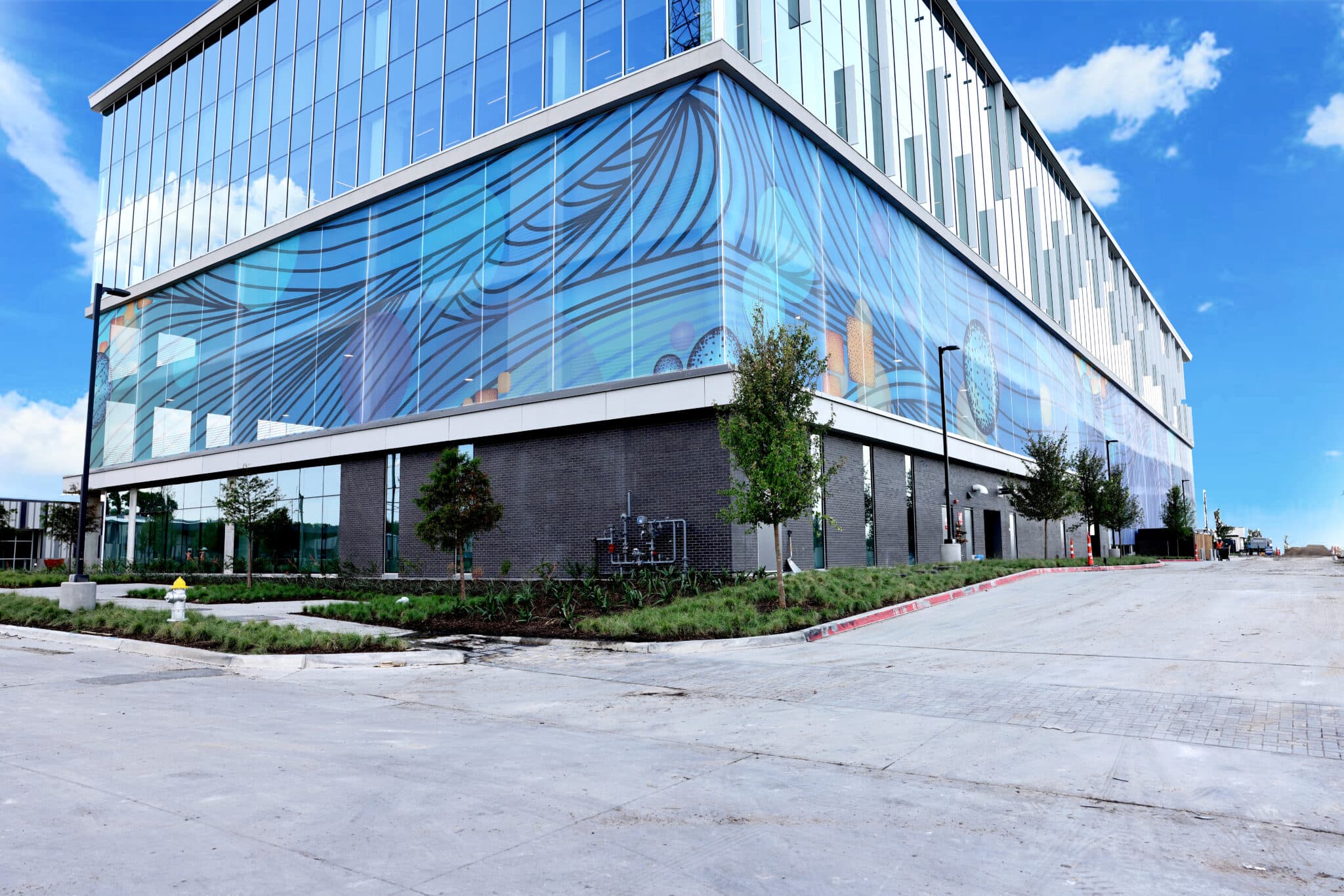 A corner shot of the blue space inspired facade that features light and dark blue bands sweeping across the imagery.
