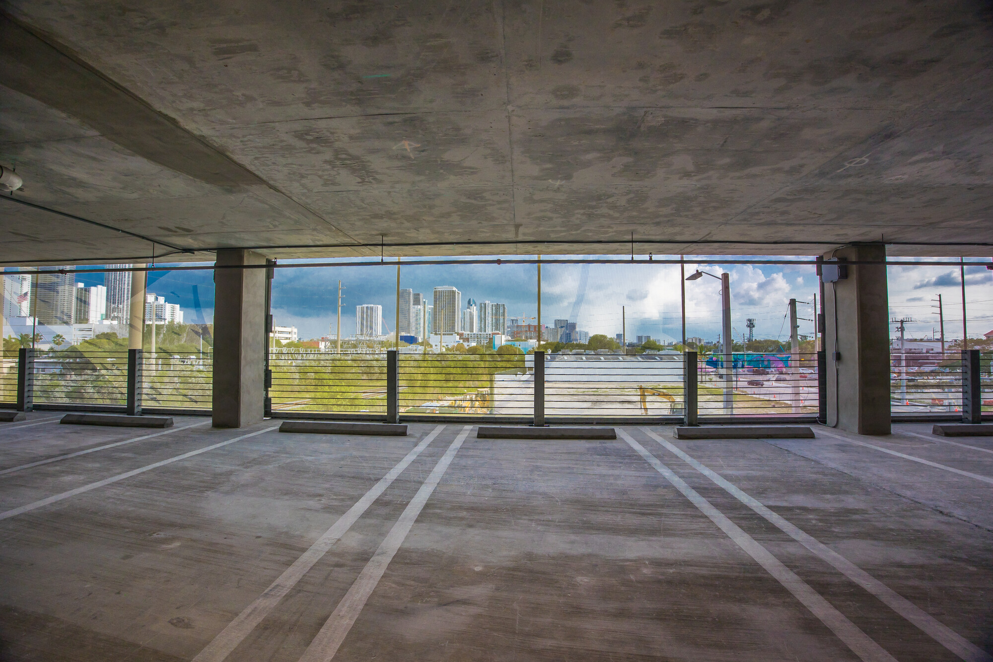 A view from inside of the garage looking out through the facade.