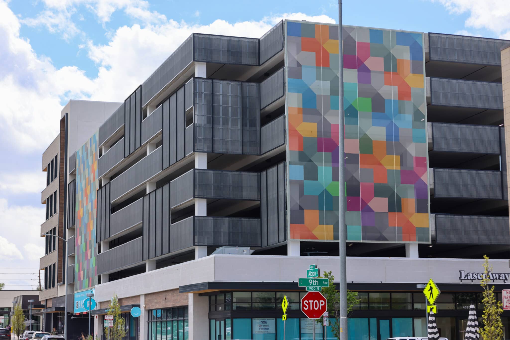 A colorful geometric facade sat on a small portion of a parking garage.