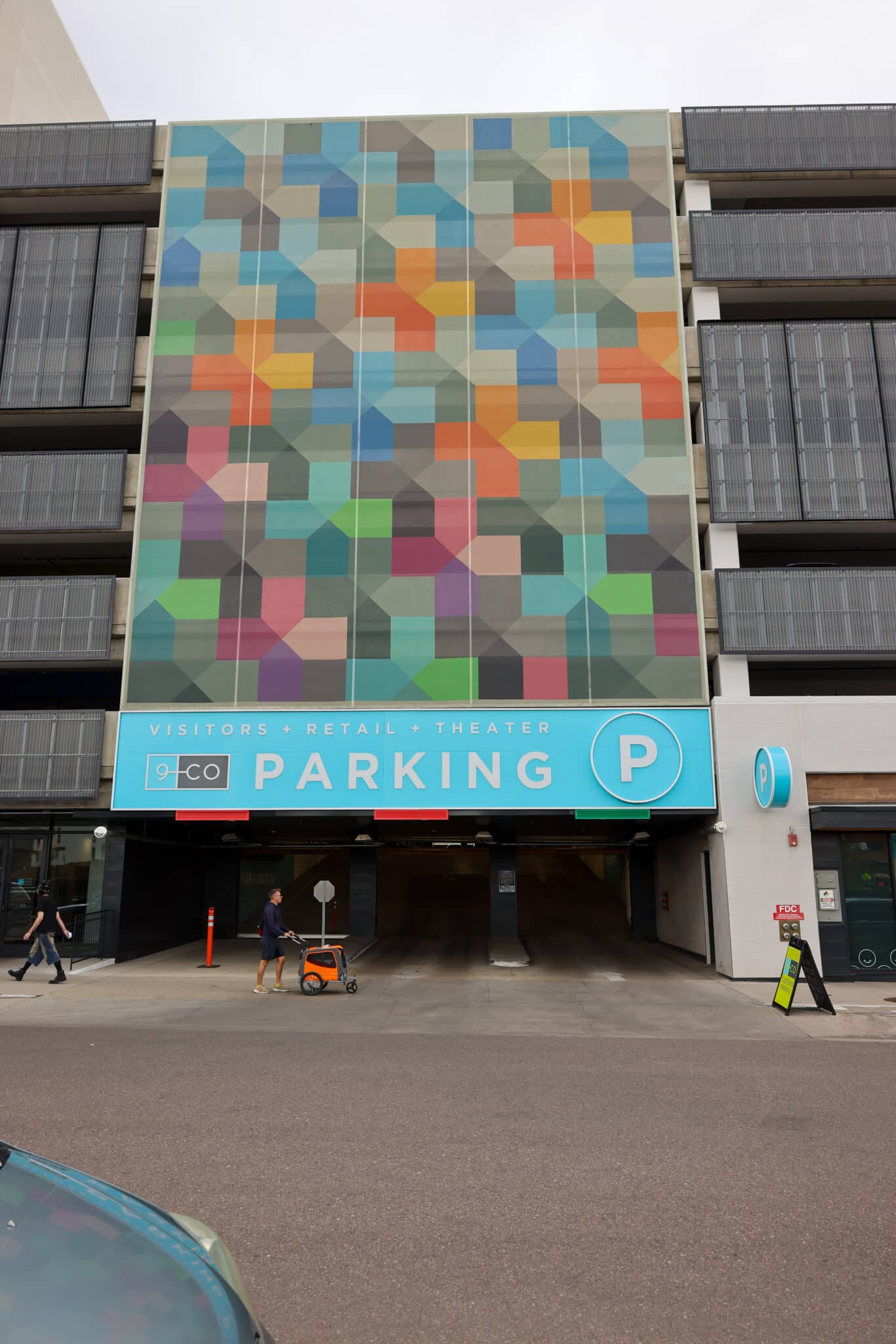 A separate facade on the parking garage with the same colors and patterns.