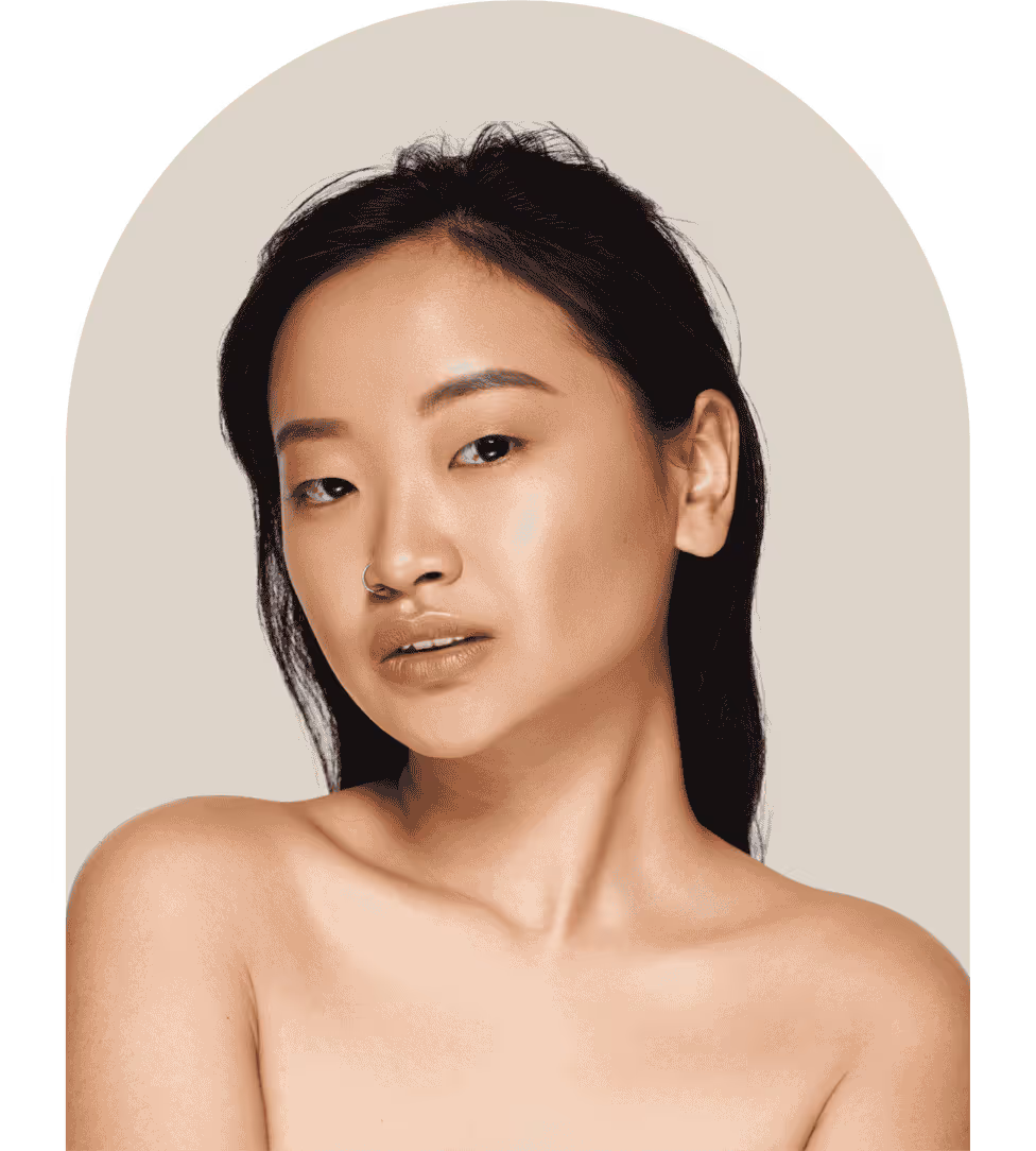 Portrait of a woman with smooth skin, dark hair, and a nose ring against a beige background.