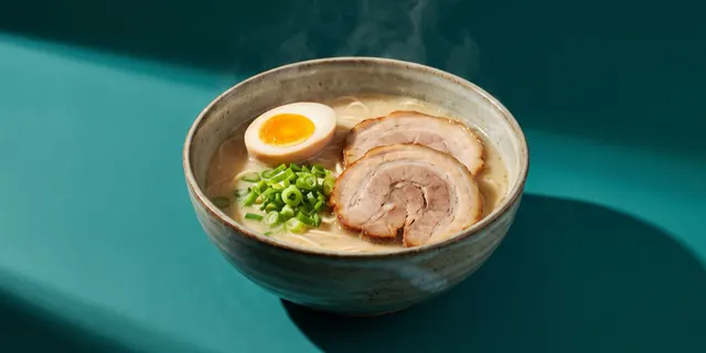 A bowl of tonkotsu ramen with a soft egg