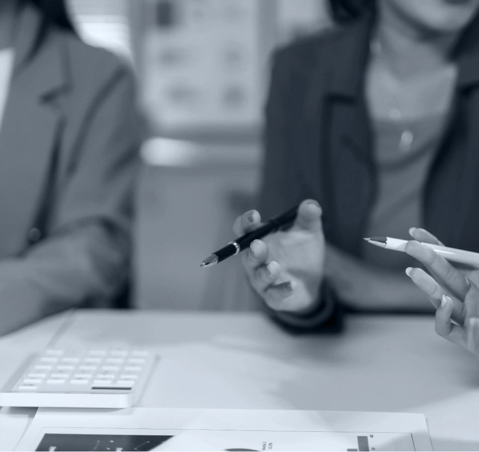woman holding pen in hand while speaking