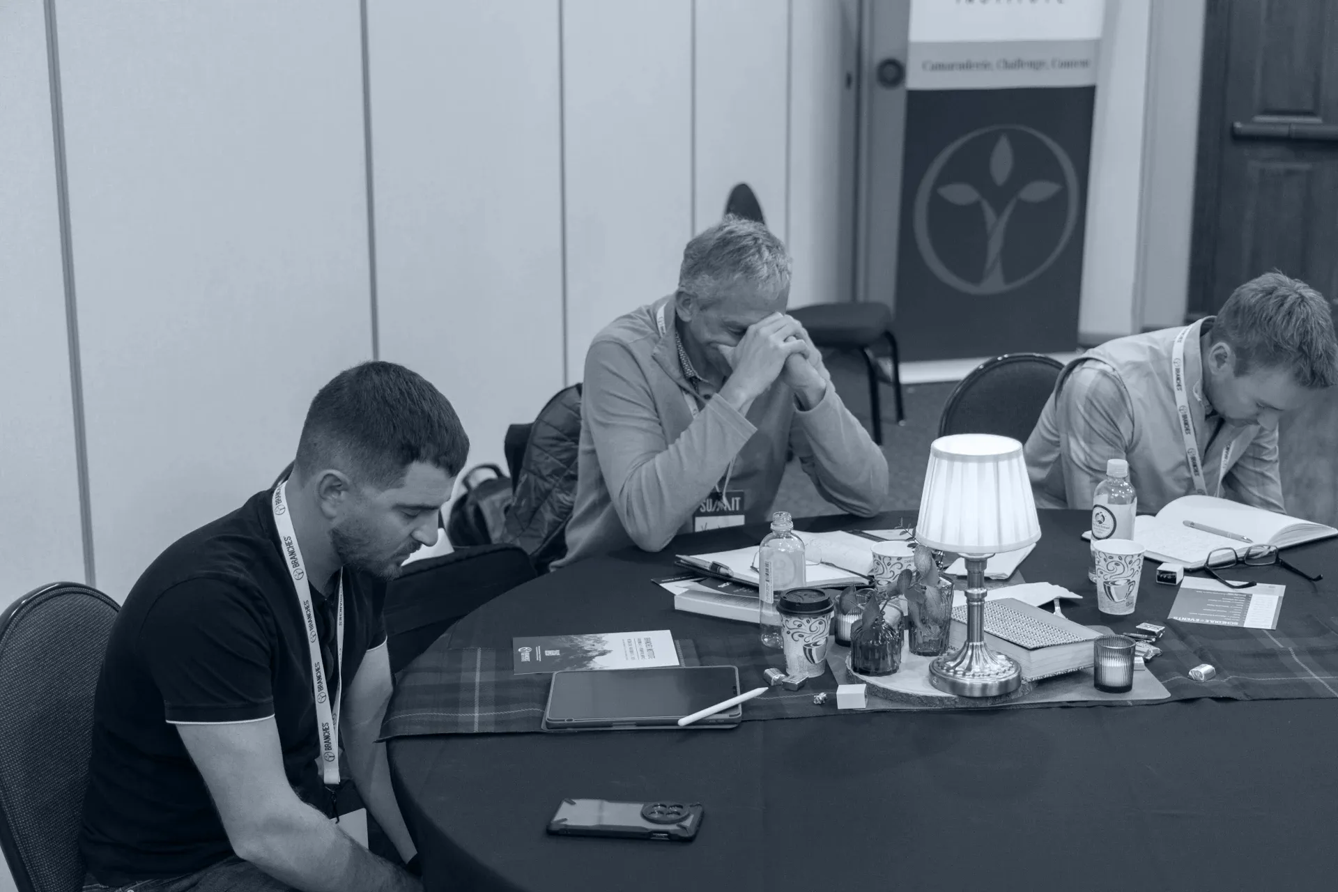 branches institute members praying around a table