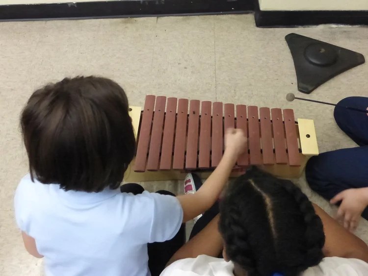 Students playing musical instruments.