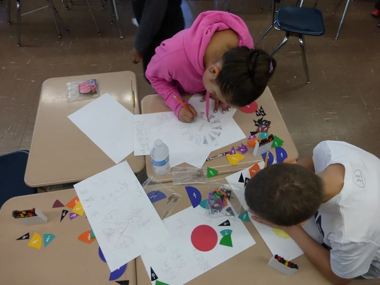 Students working on art and math activities.