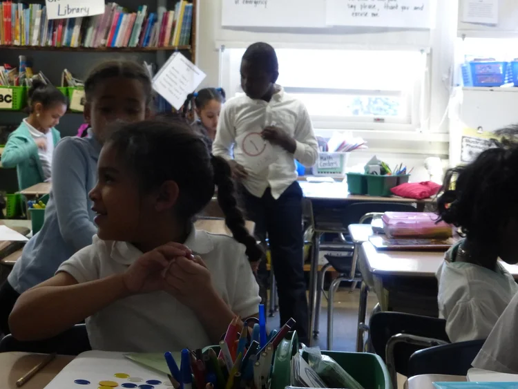 Students interacting in a classroom.