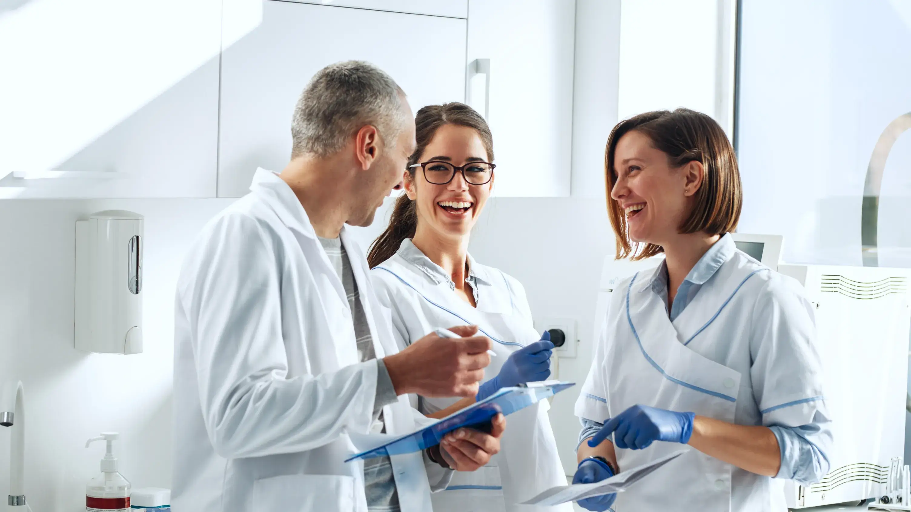 a group of people standing around each other in a room