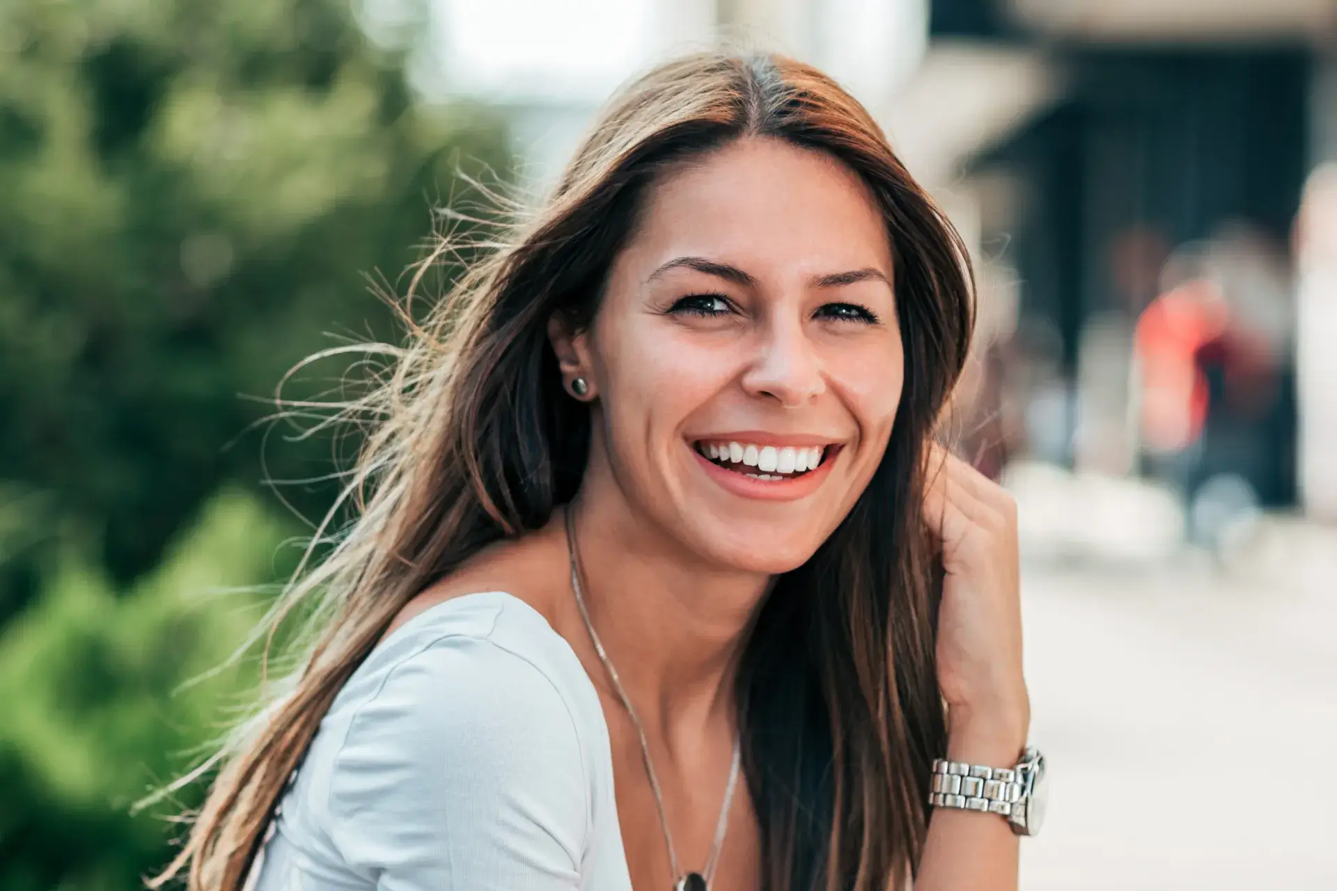 a woman with long brown hair smiling at the camera