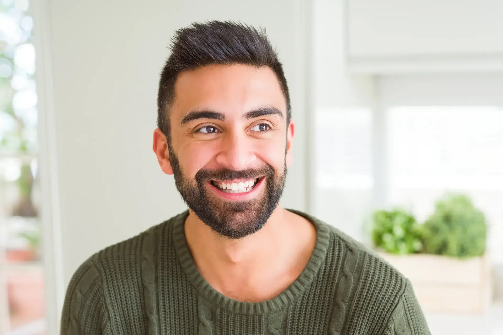a man with a beard smiling at the camera