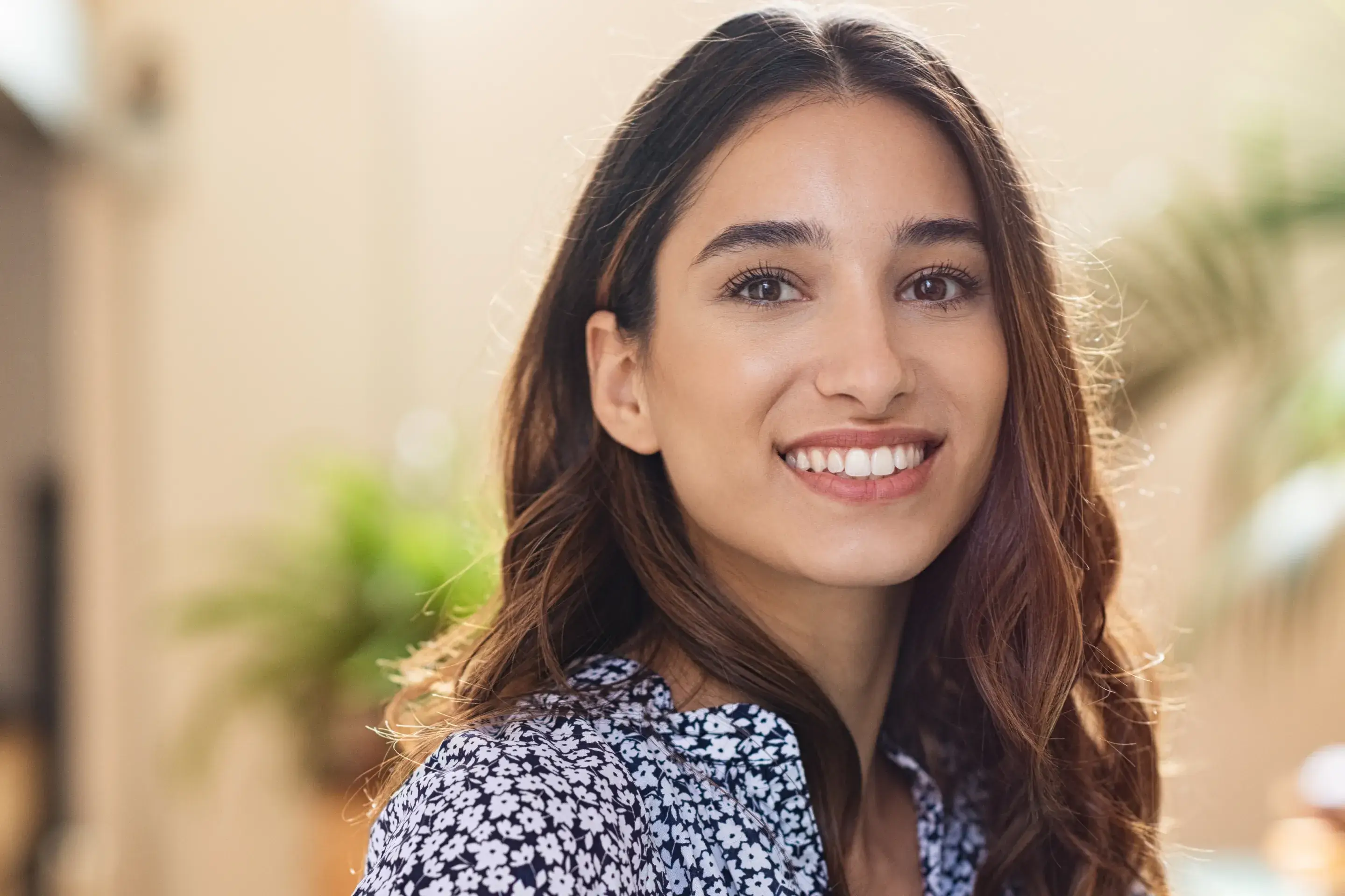 a woman with long hair smiling at the camera