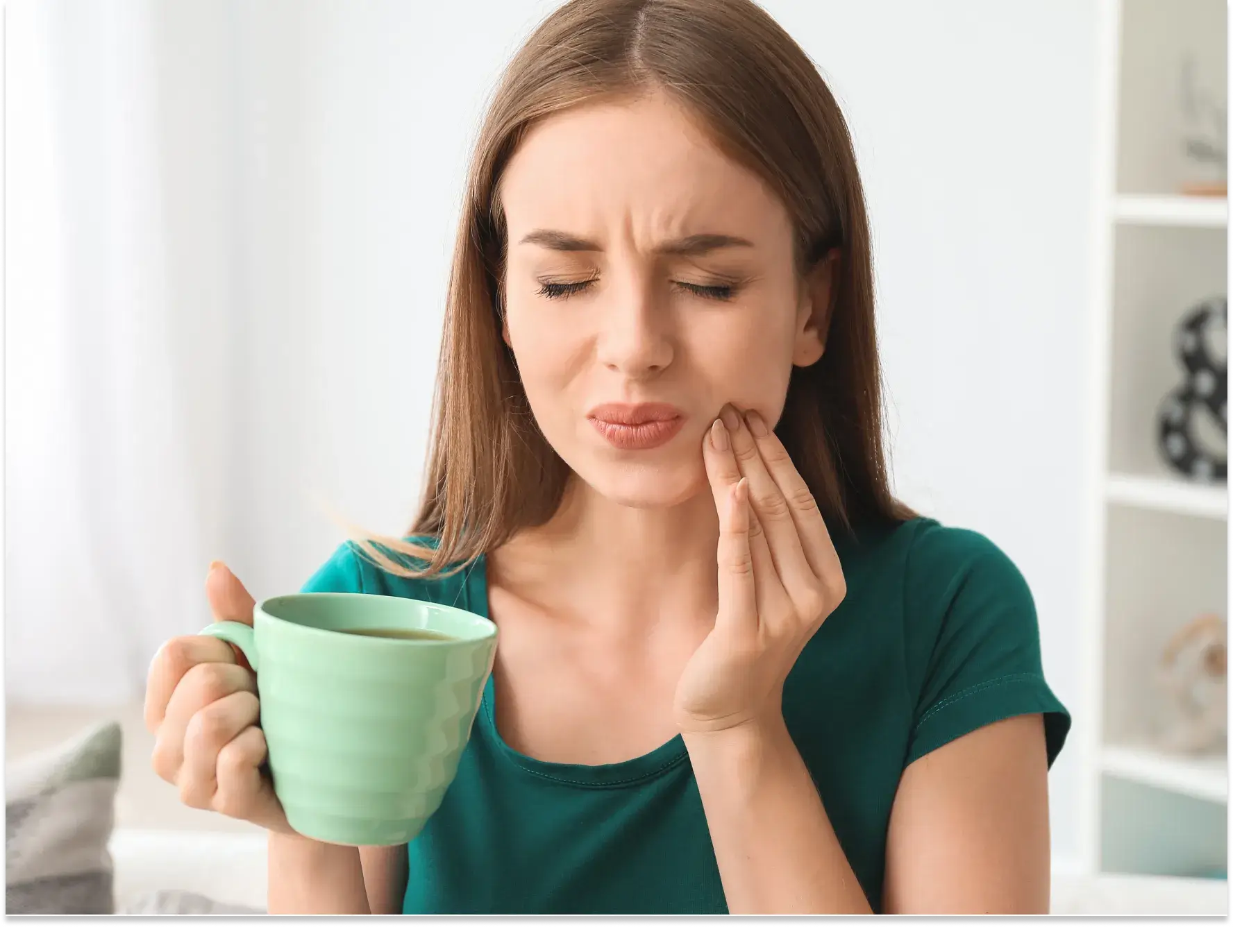 a woman holding a cup of tea with her hands