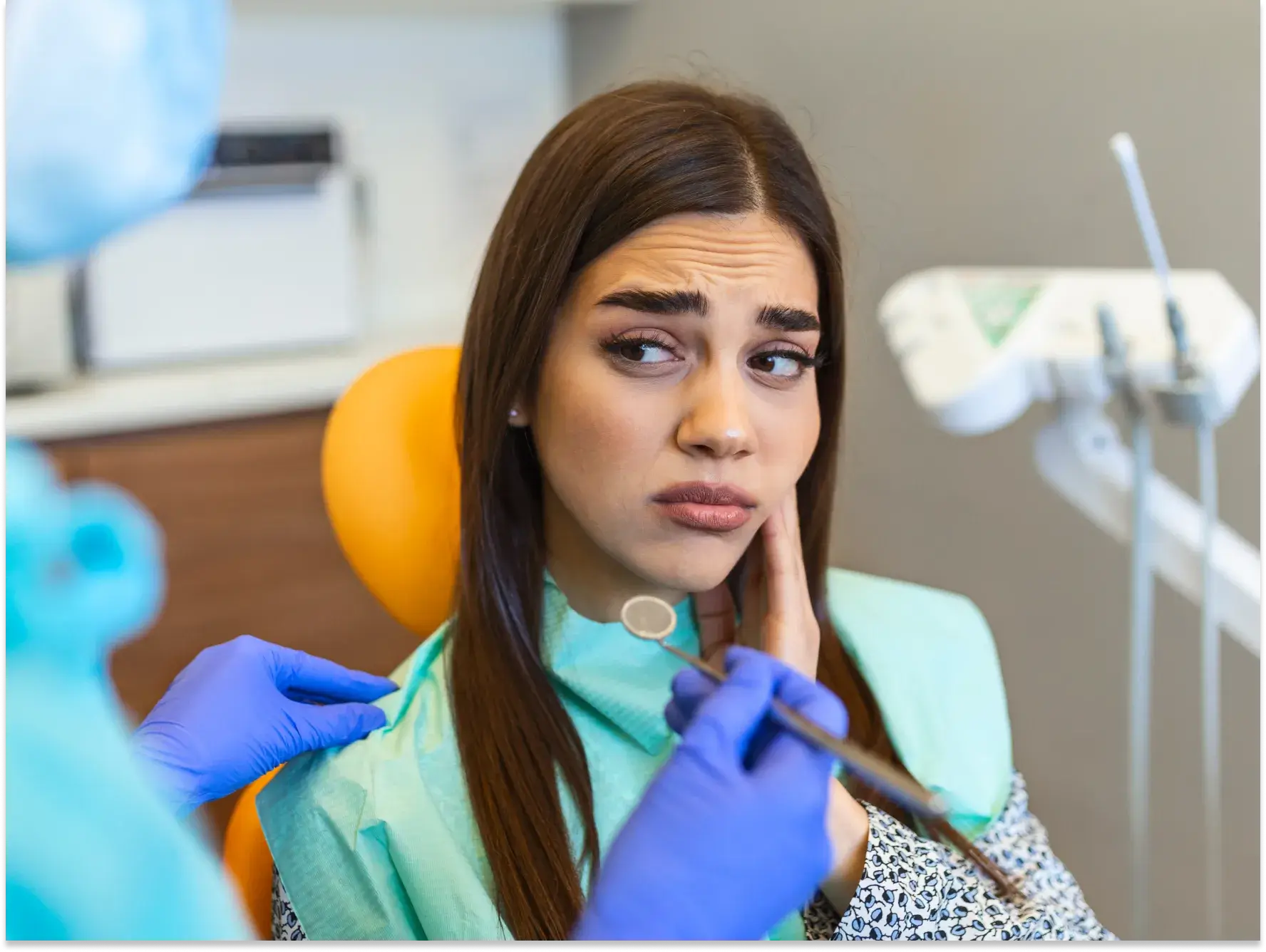 a woman getting her teeth checked by a dentist