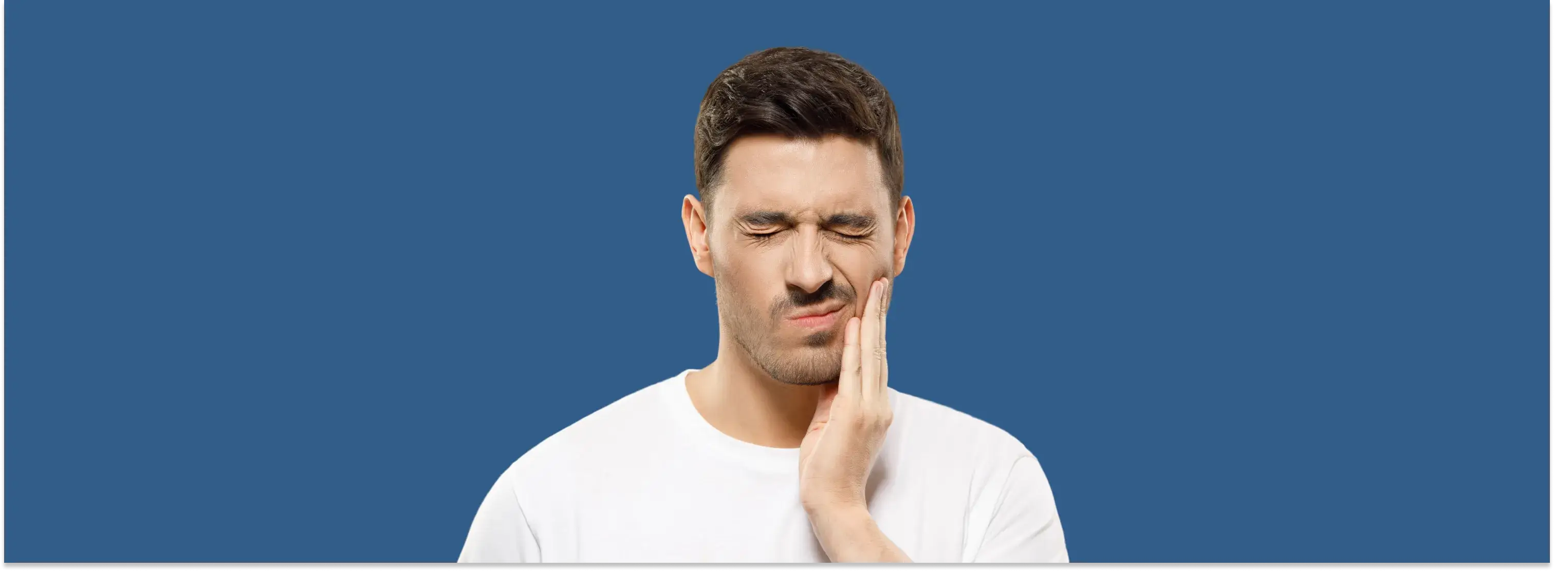 a man holding his hand to his face