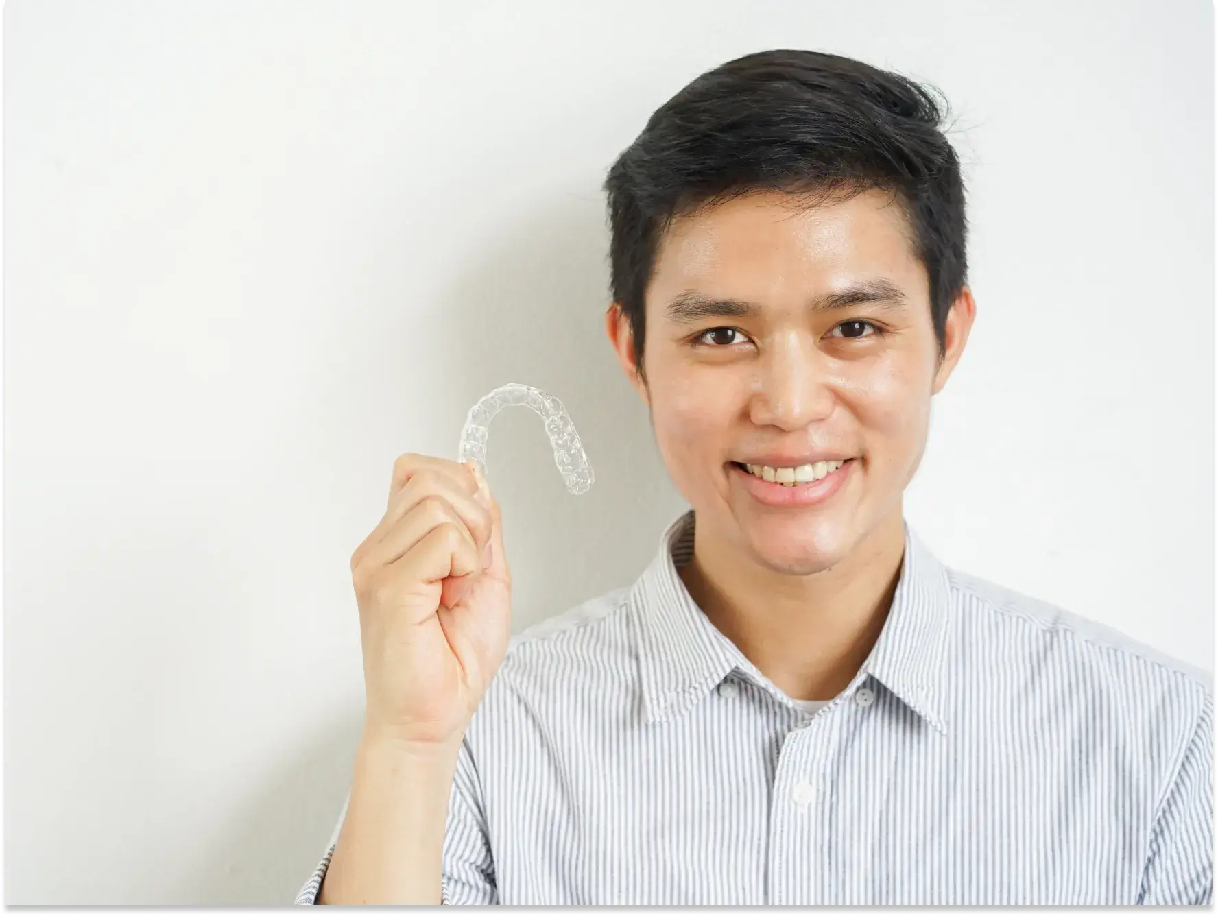 a man holding a toothbrush in front of his face