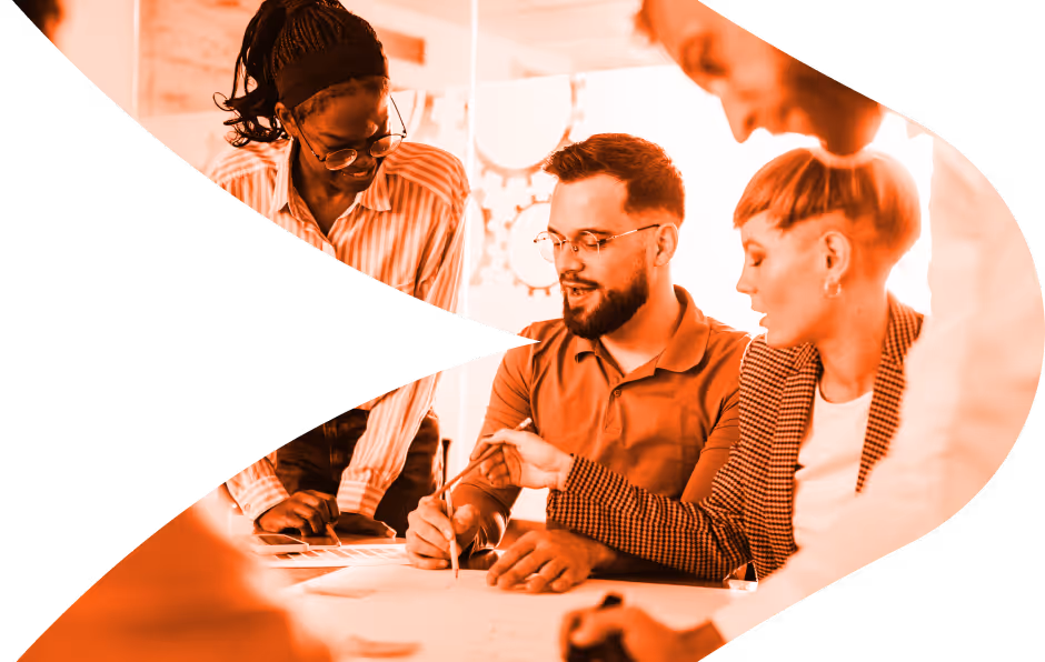A group of diverse coworkers collaborating and discussing ideas around a table with documents.
