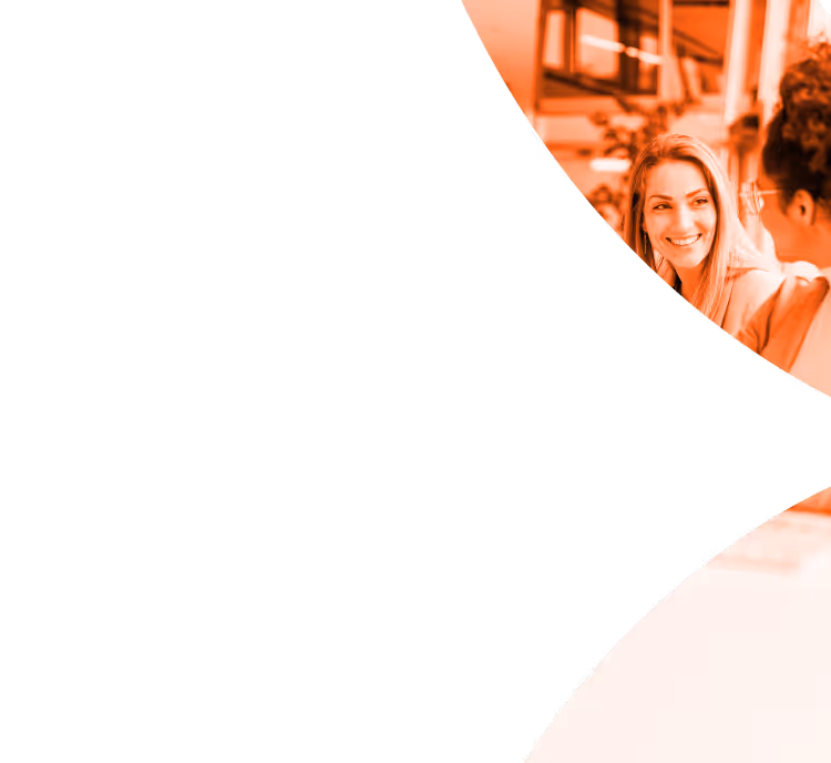 Two women smiling and talking in a bright indoor setting, with an orange overlay.