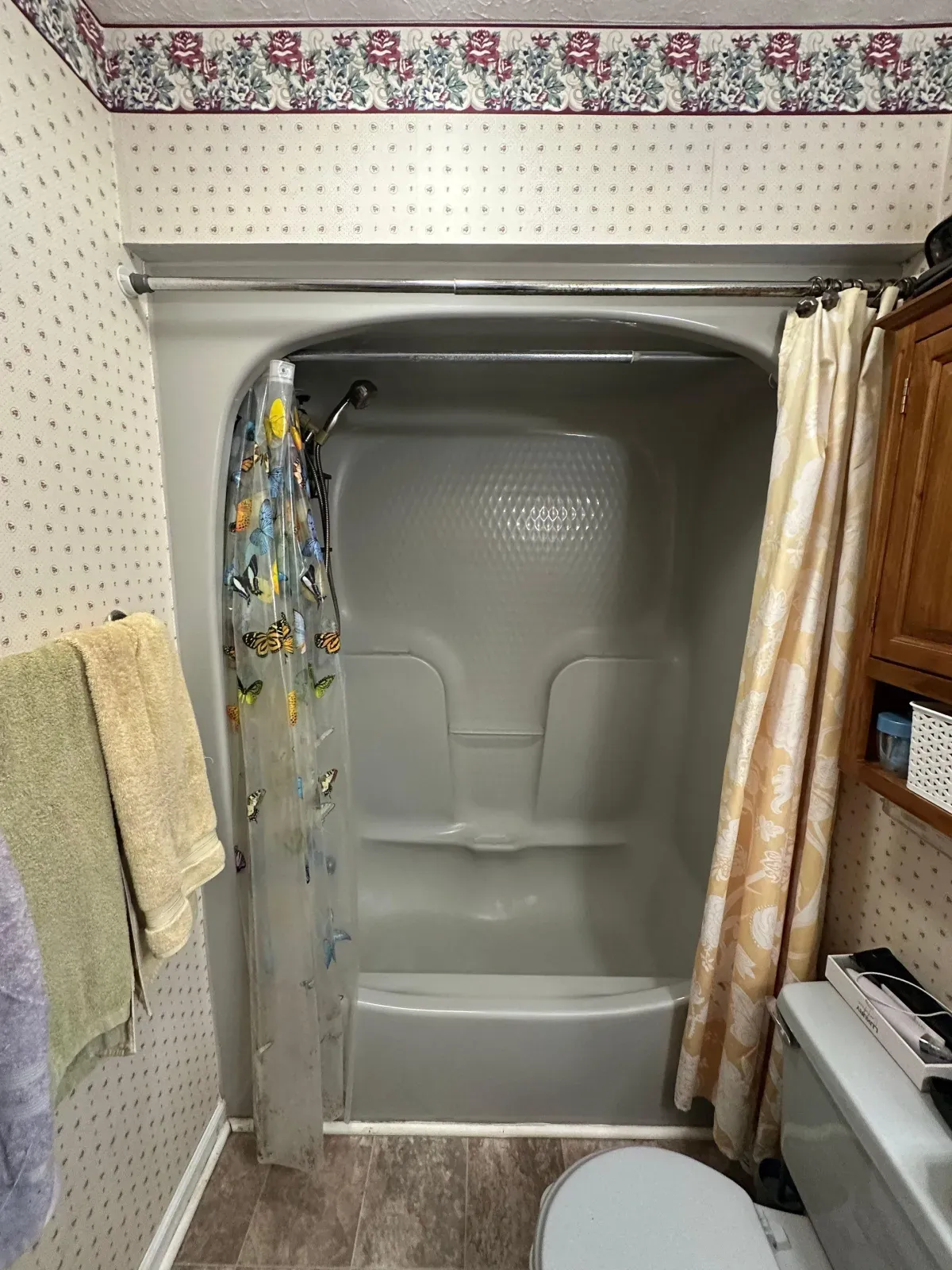 Before: dated tub with shower curtain