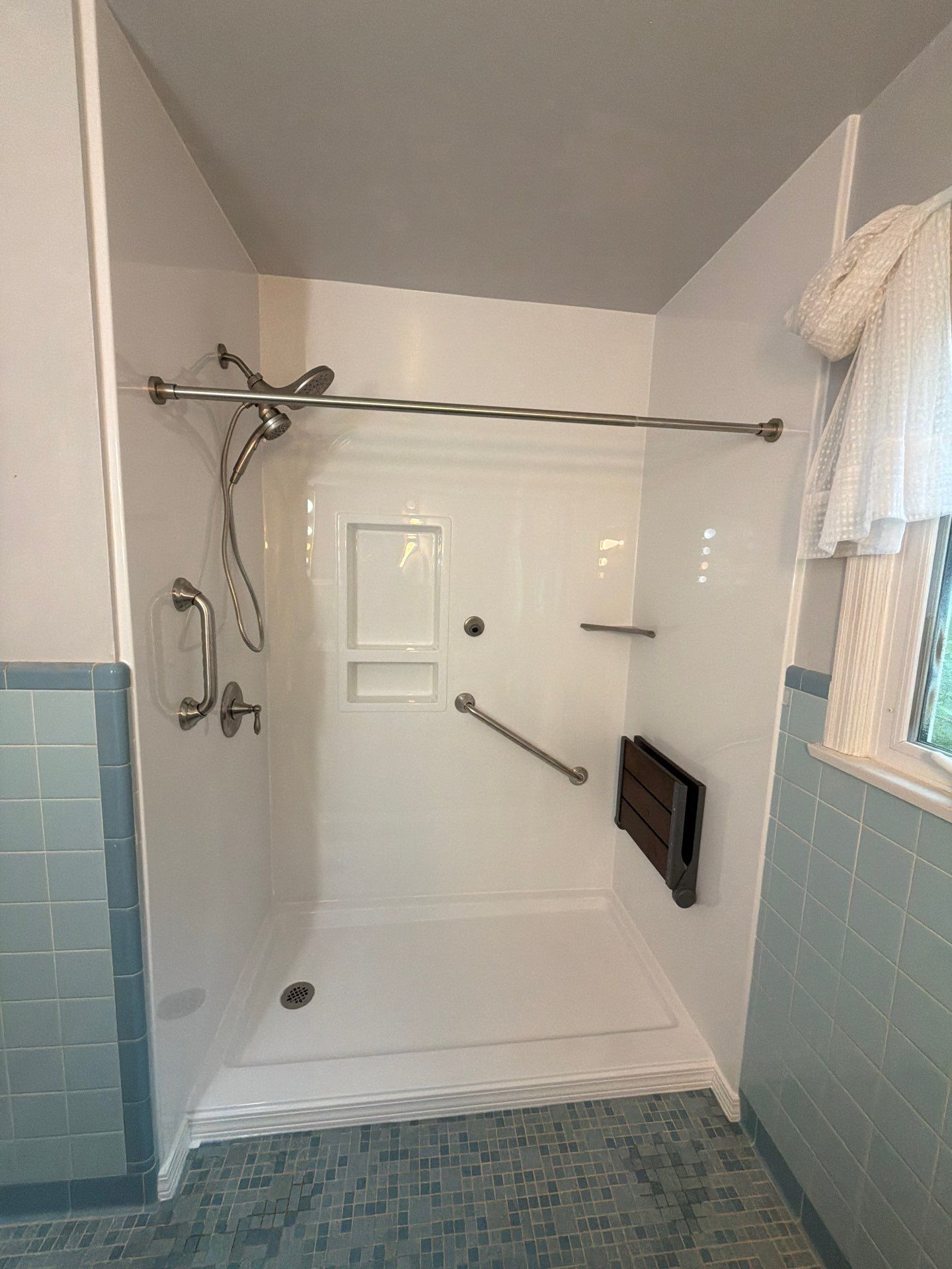 After: white walk-in shower with grab bar and seat