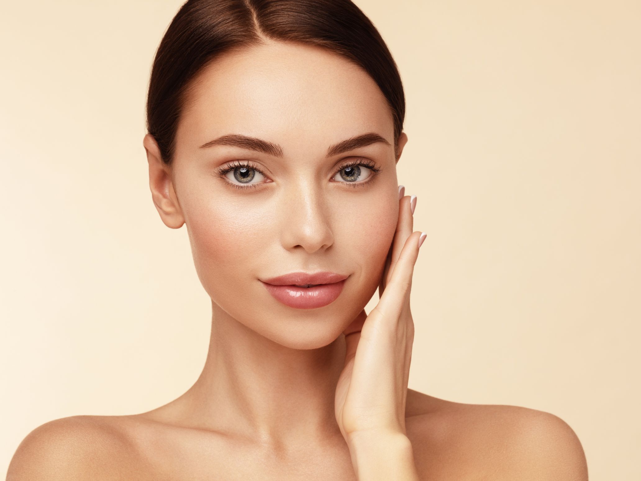 young woman touching face