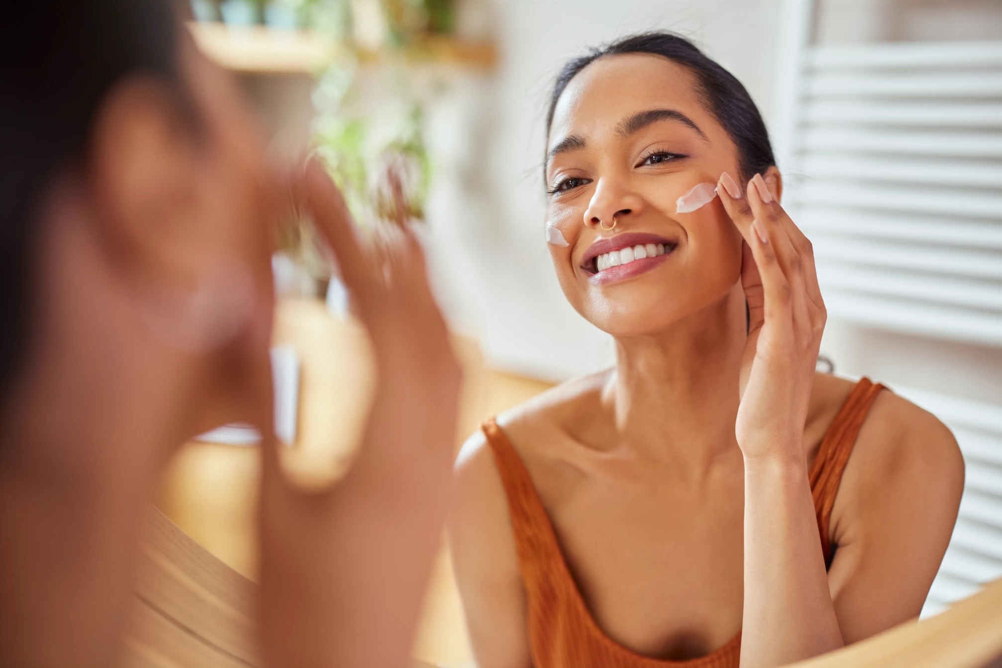 woman applying moisturizer
